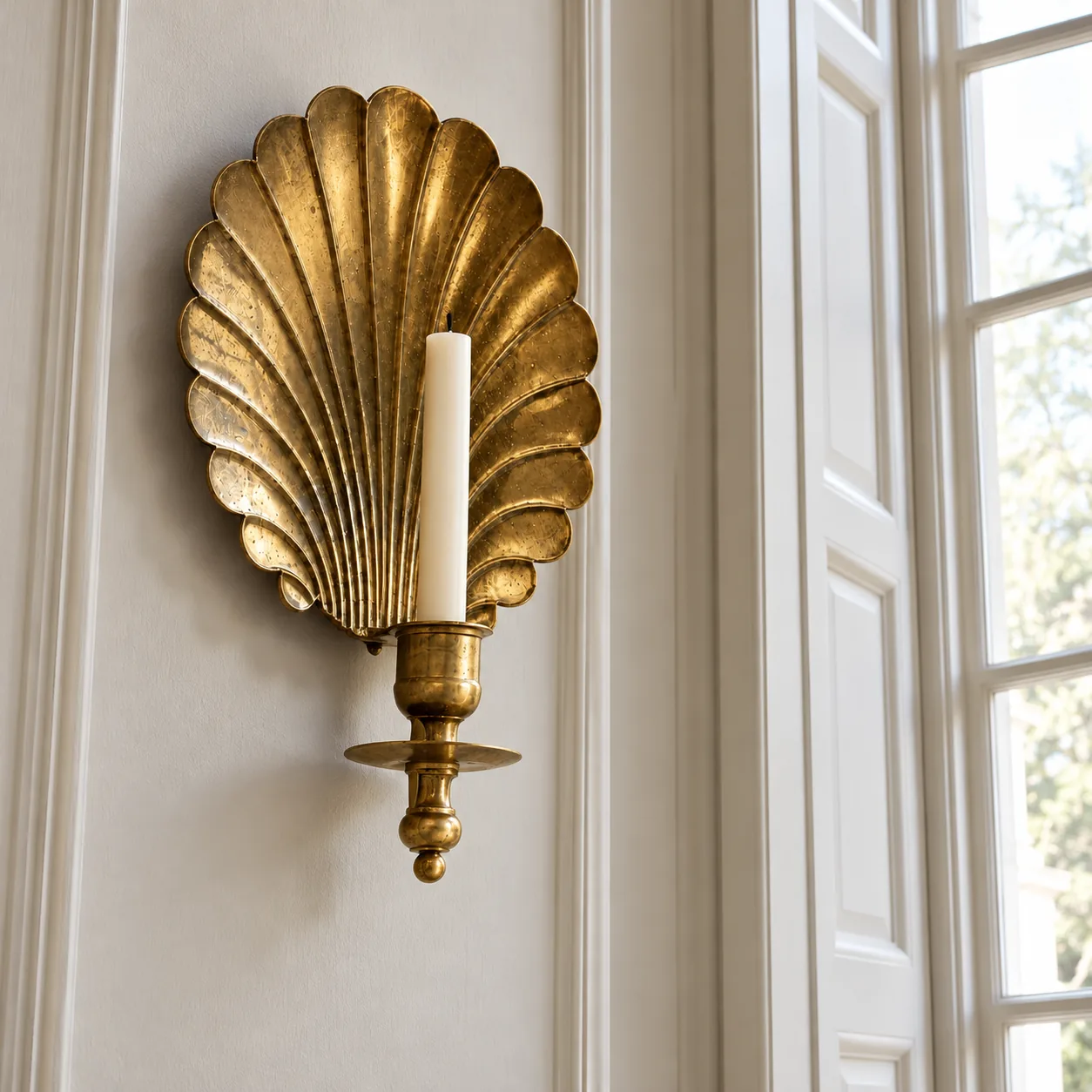 Shell sconce beside an entry window