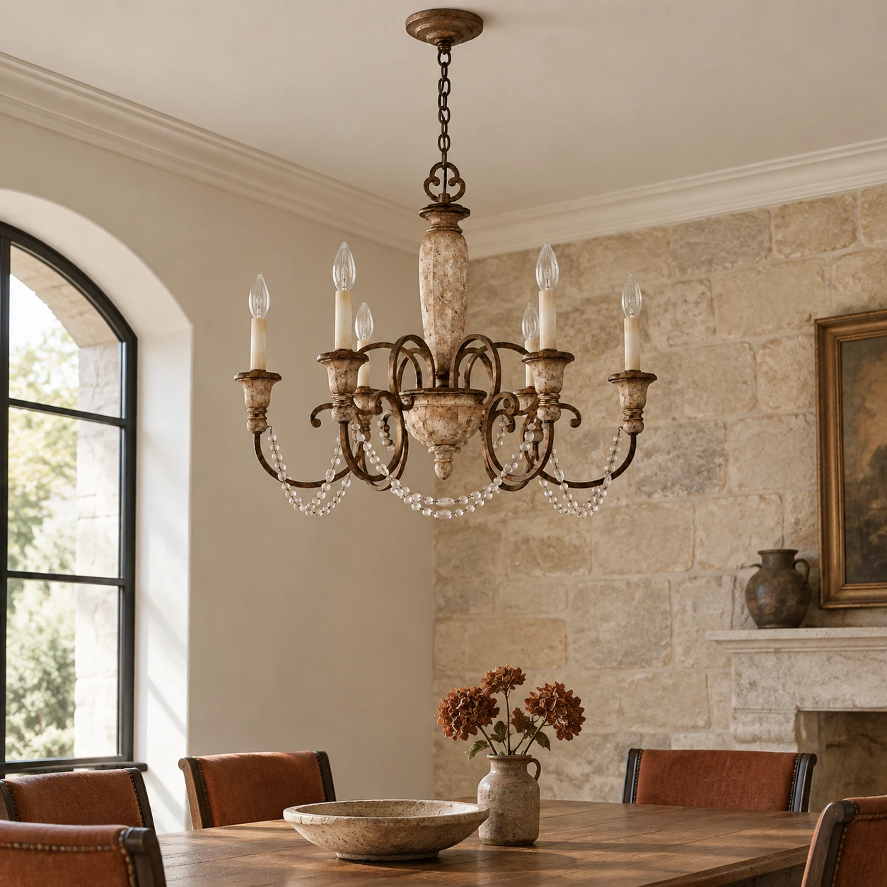 Six-light carved wood chandelier in a limestone B&B dining room