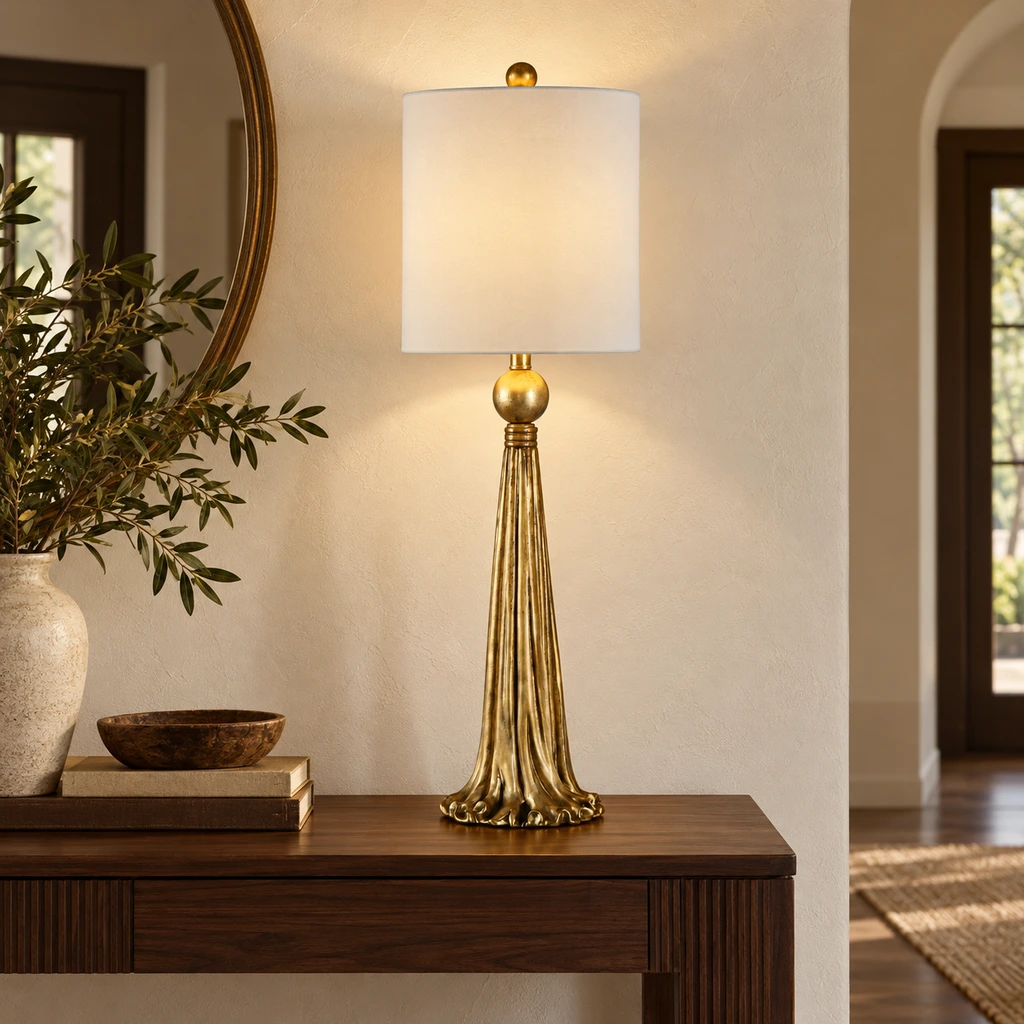 Carved gold table lamp on a walnut console