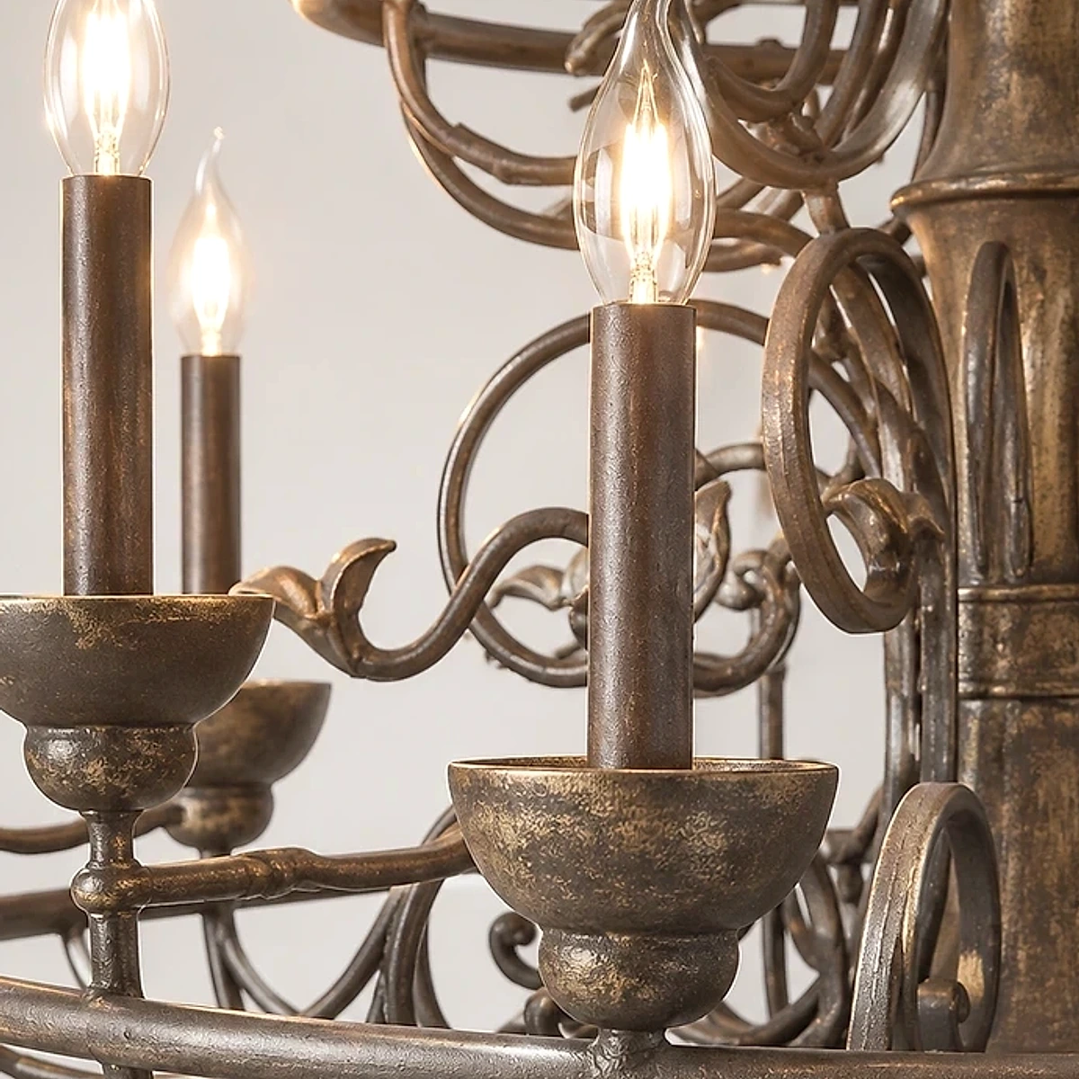 Close detail of the candle-style socket, scrolling arms and carved central stem