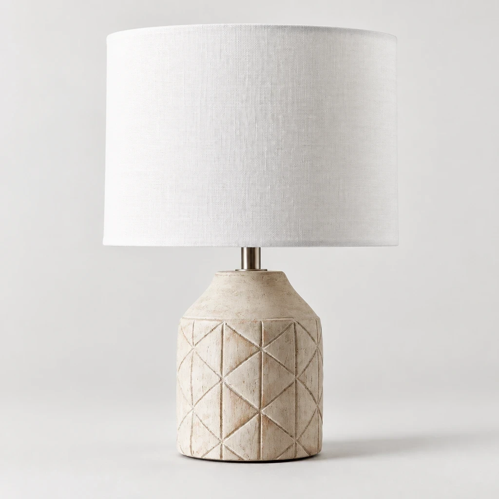 Close detail of the repeated black geometric pattern on the carved wood lamp base