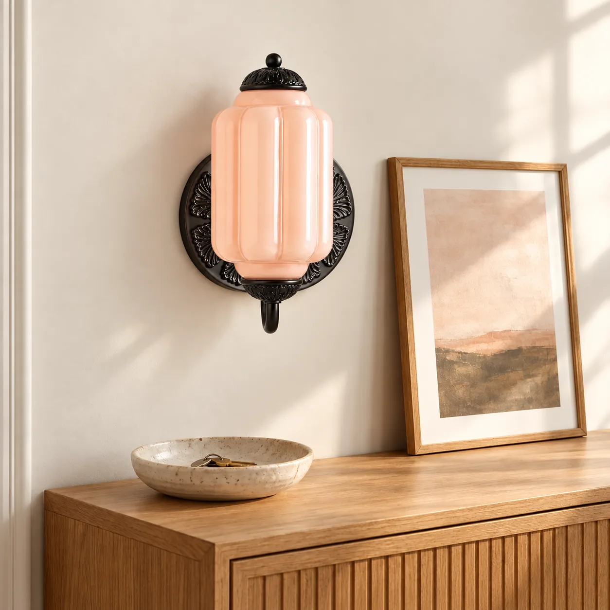 One pink Eloise wall sconce with black metal, flush-mounted in an entry