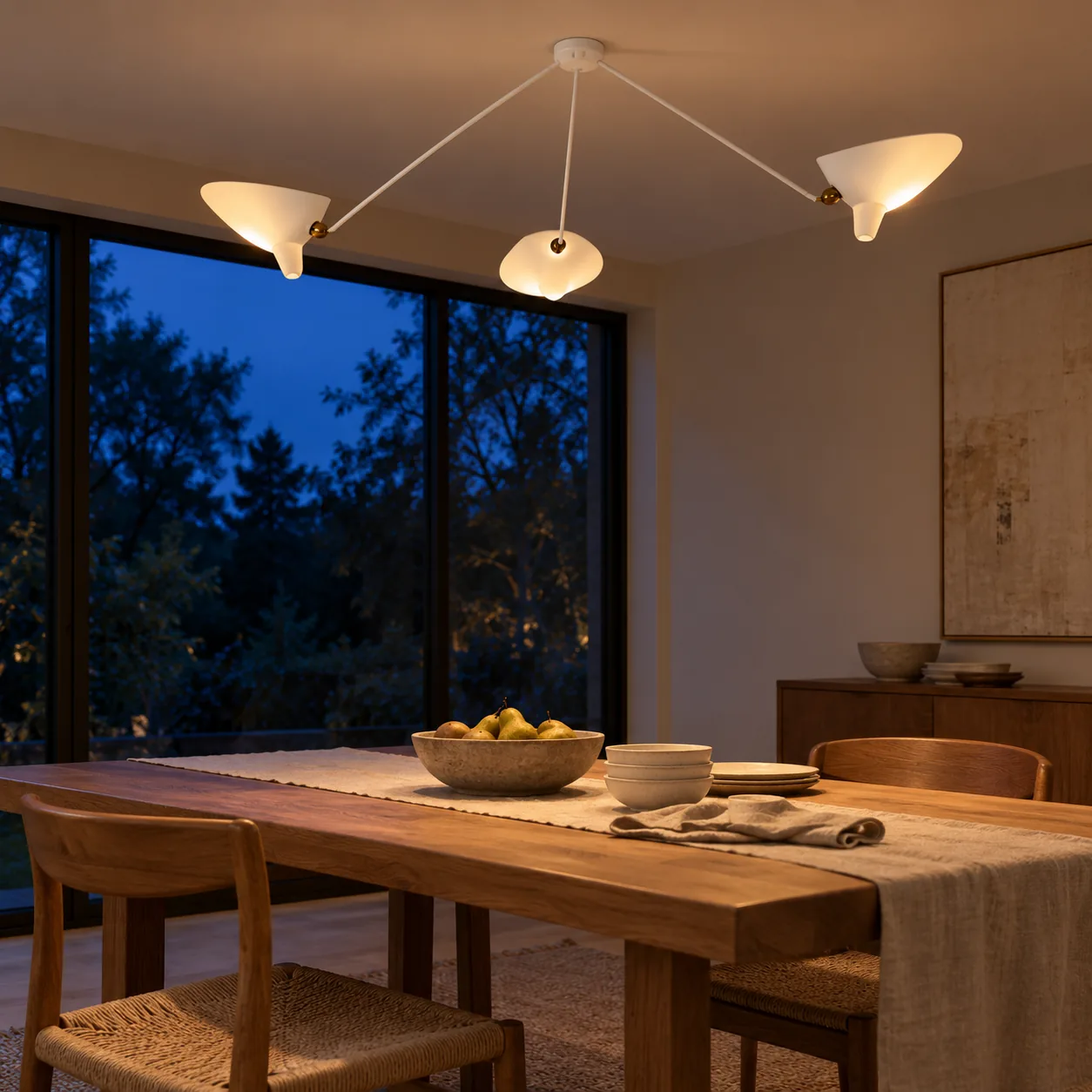 White 3-arm ceiling light switched on at blue hour