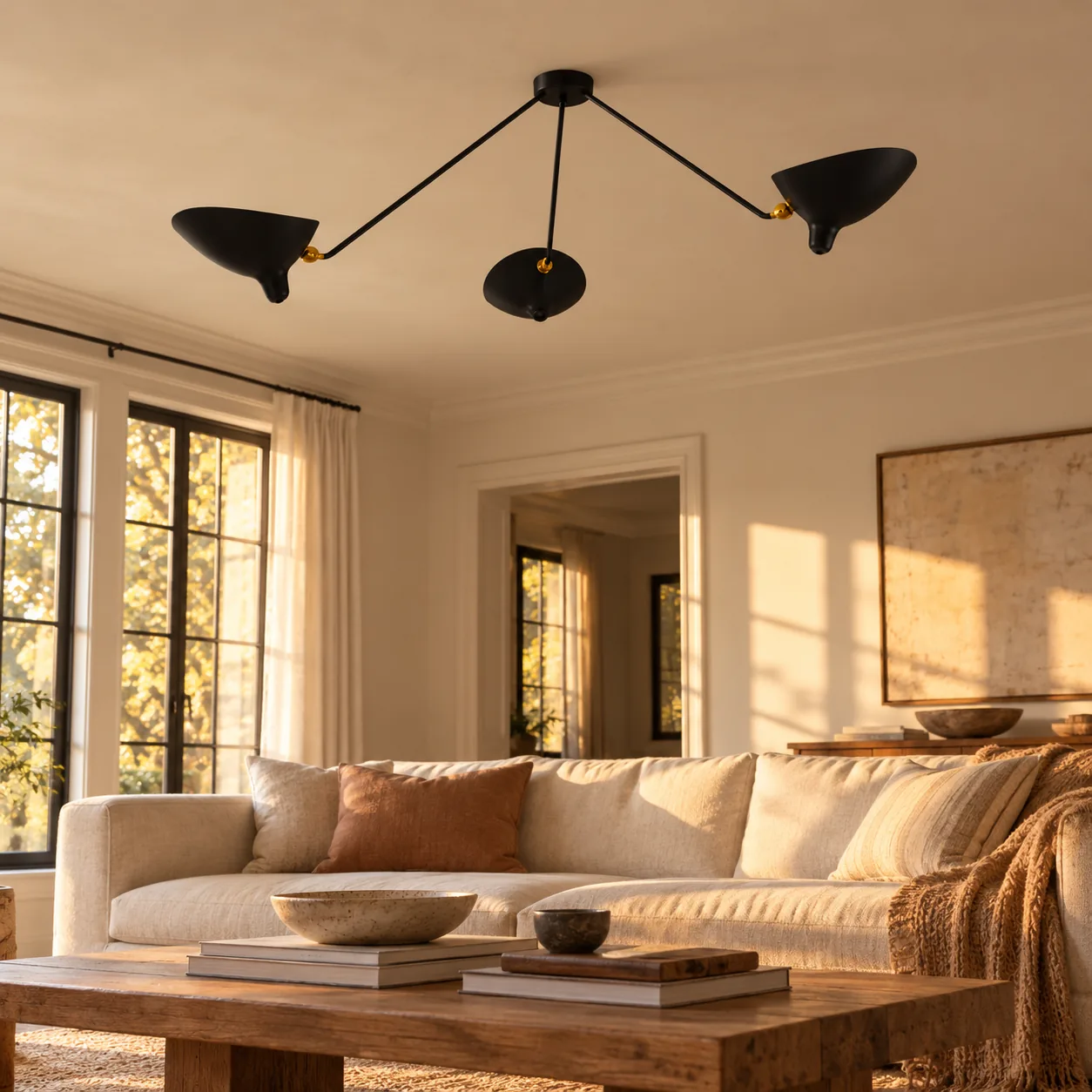 Black 3-arm ceiling light above a sofa