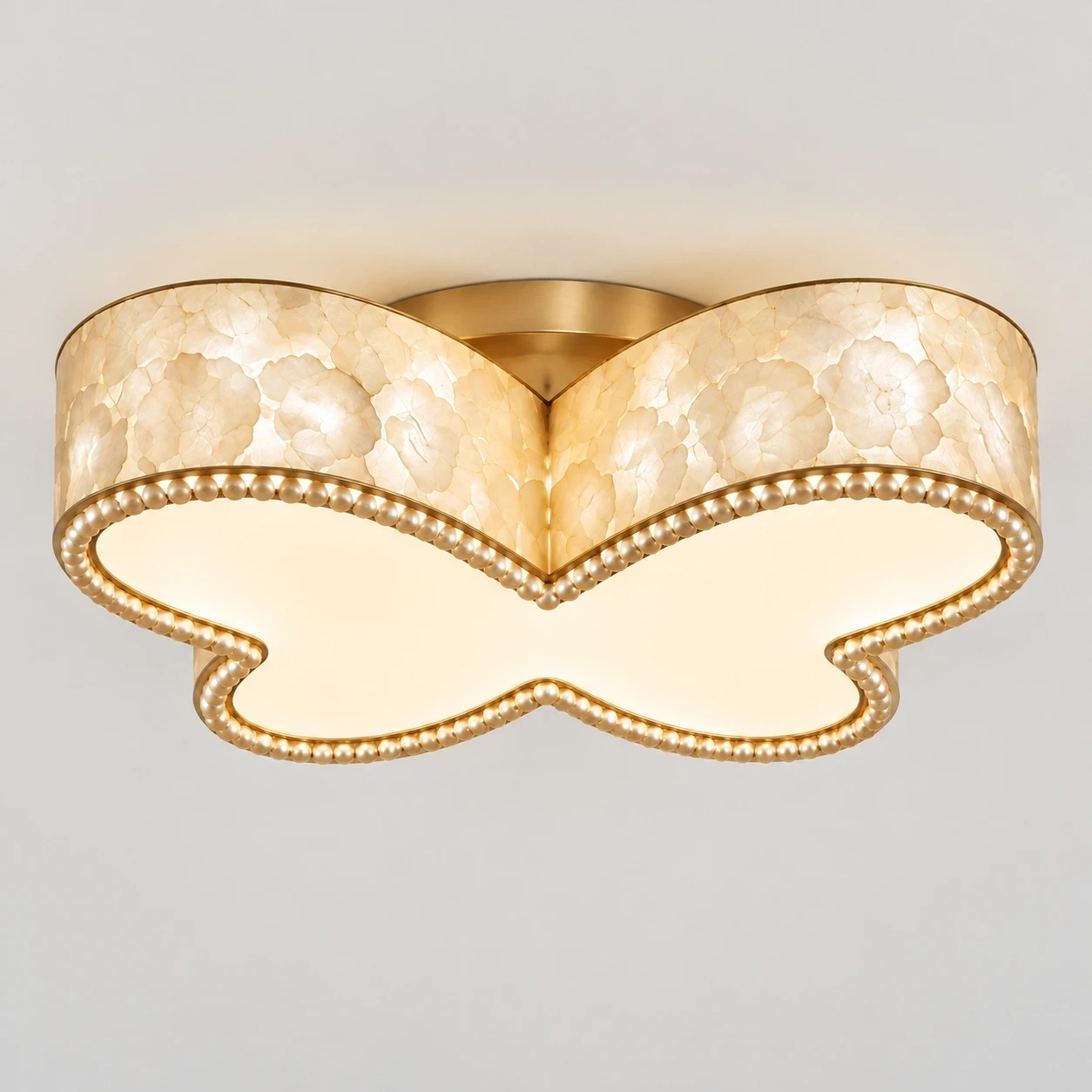 Wushlp Vintage Butterfly Shell Flush Mount Ceiling Light switched on in a neutral studio