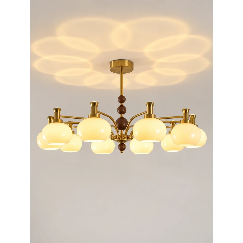 Maeve French Multi-Light Glass Wood Chandelier switched on in a neutral studio