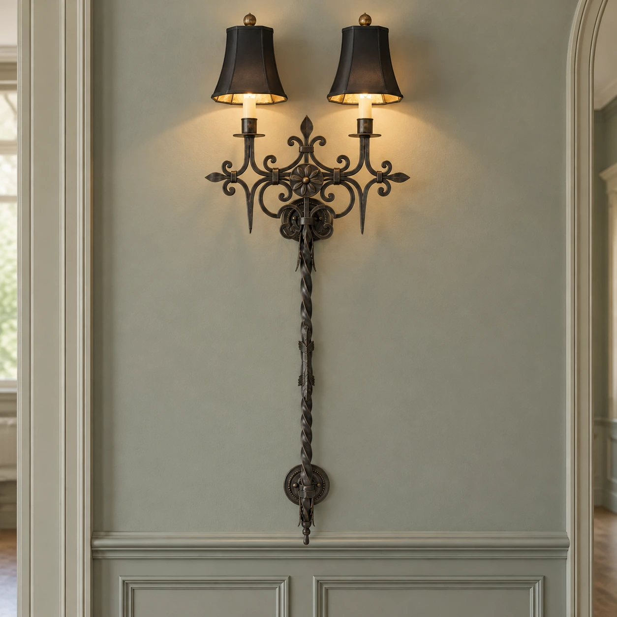 Black distressed iron wall sconce in a formal paneled hall