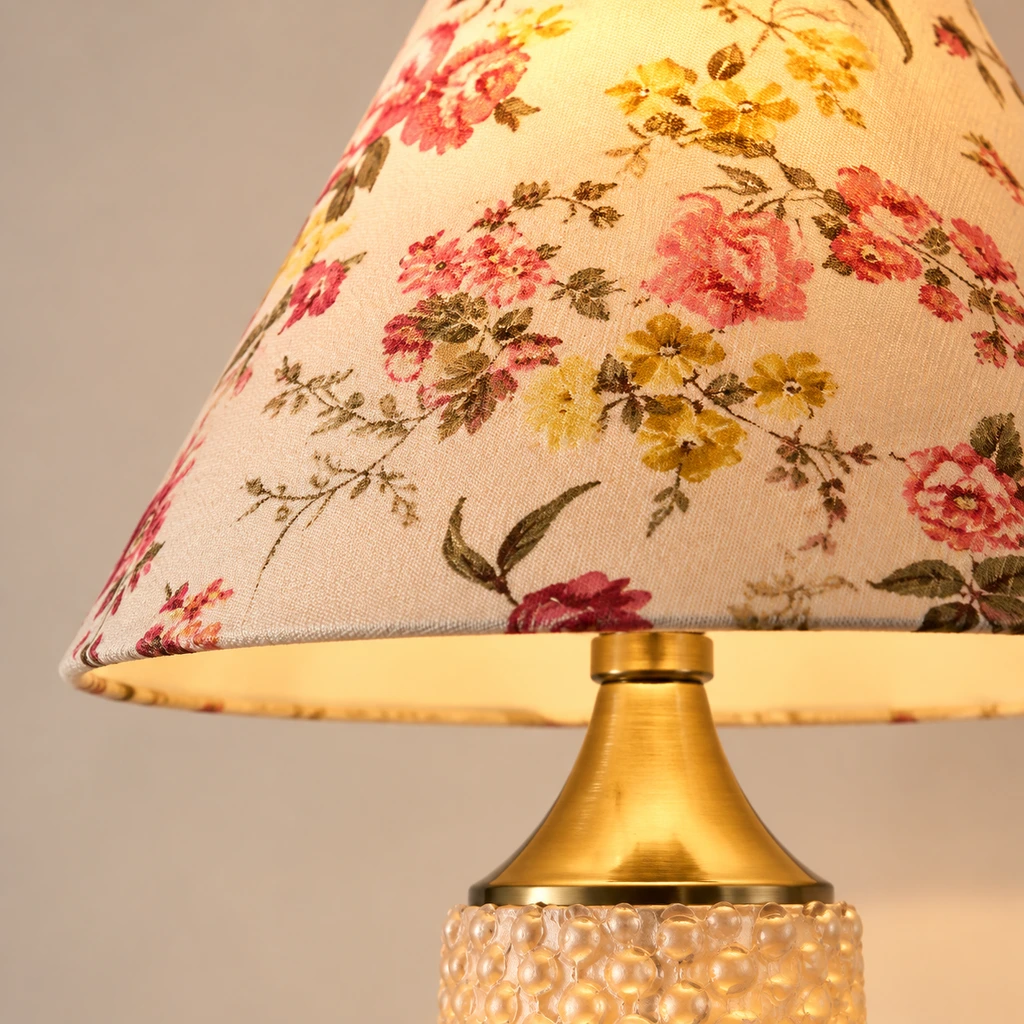 Close detail of the floral fabric shade and brass connector