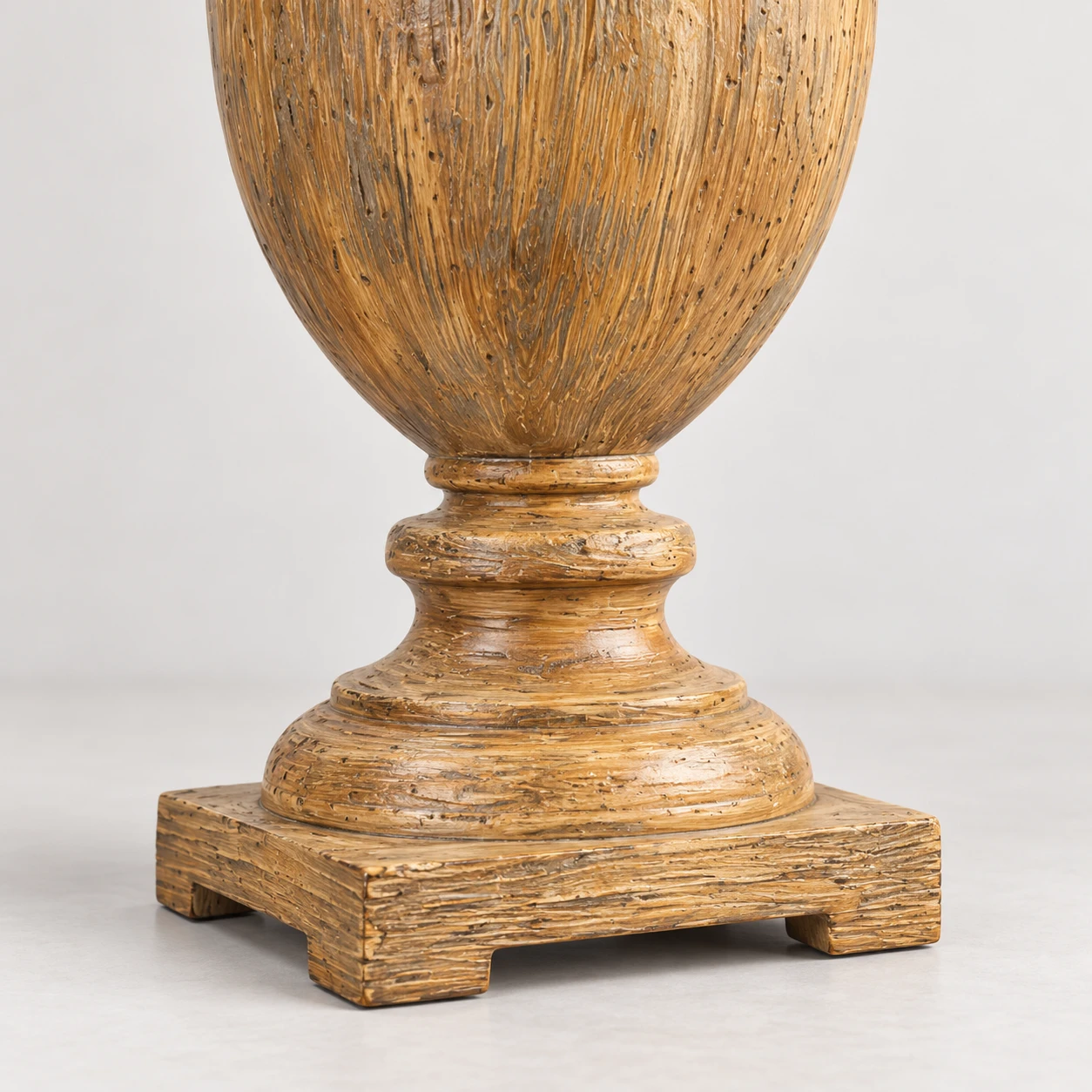 Close detail of the wood finial and square pedestal base