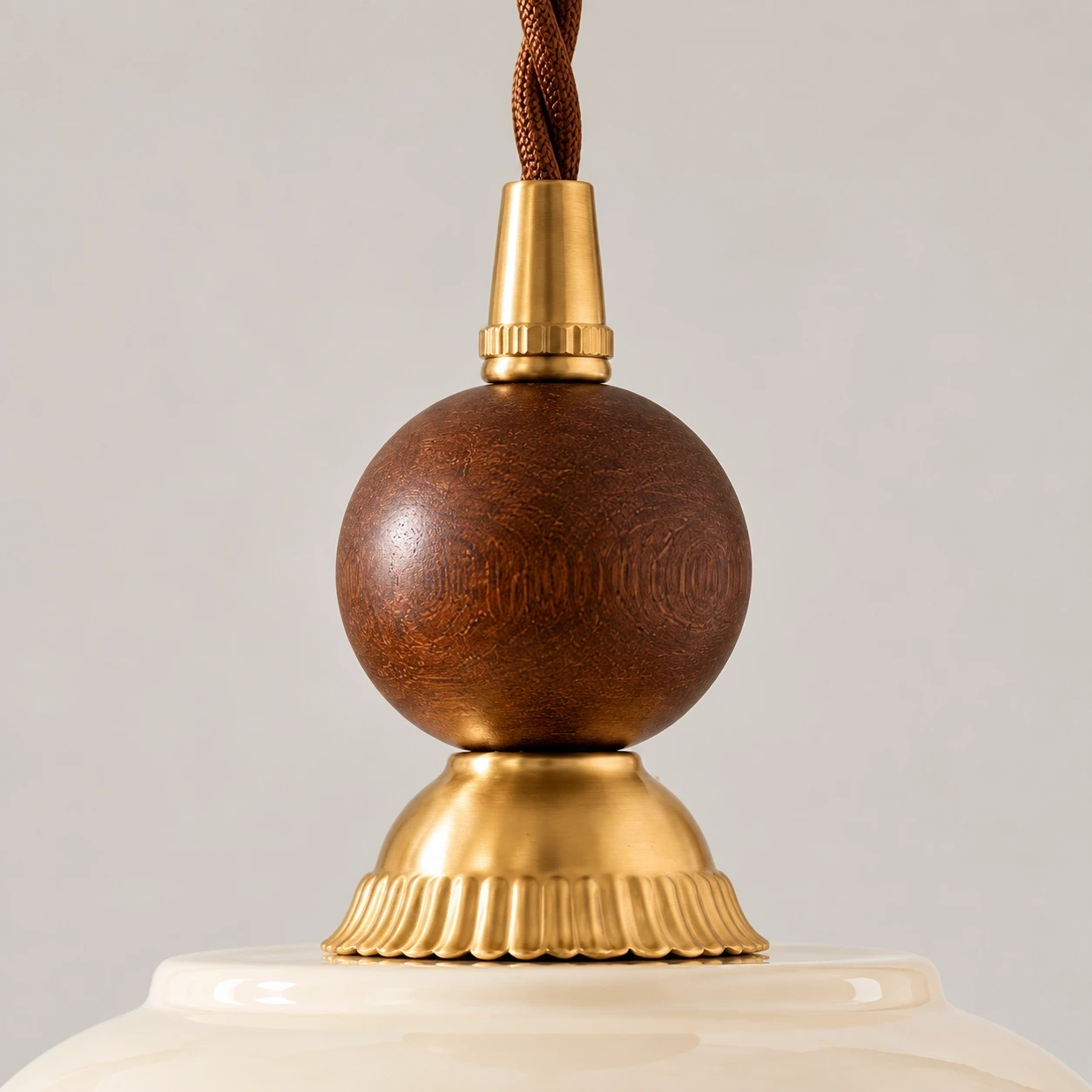 Dark solid-wood bead and brass hardware detail