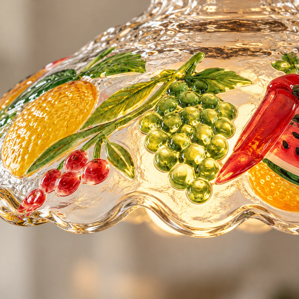Close detail of painted fruit relief on clear glass