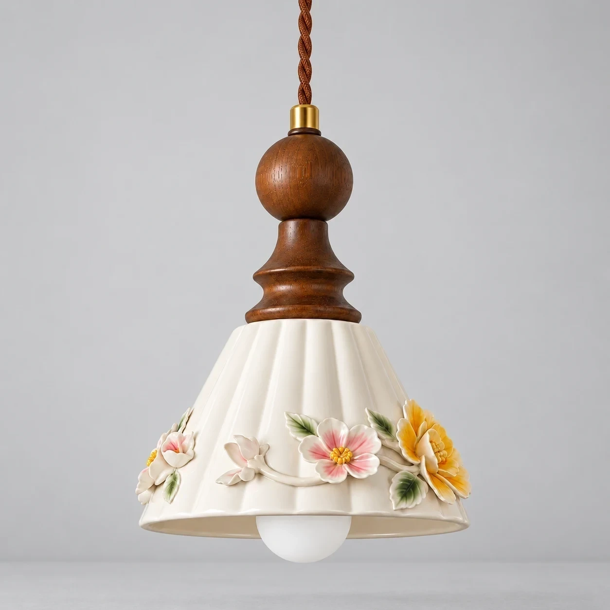 Vintage Floral Ceramic and Wood Pendant Light switched off in a neutral studio