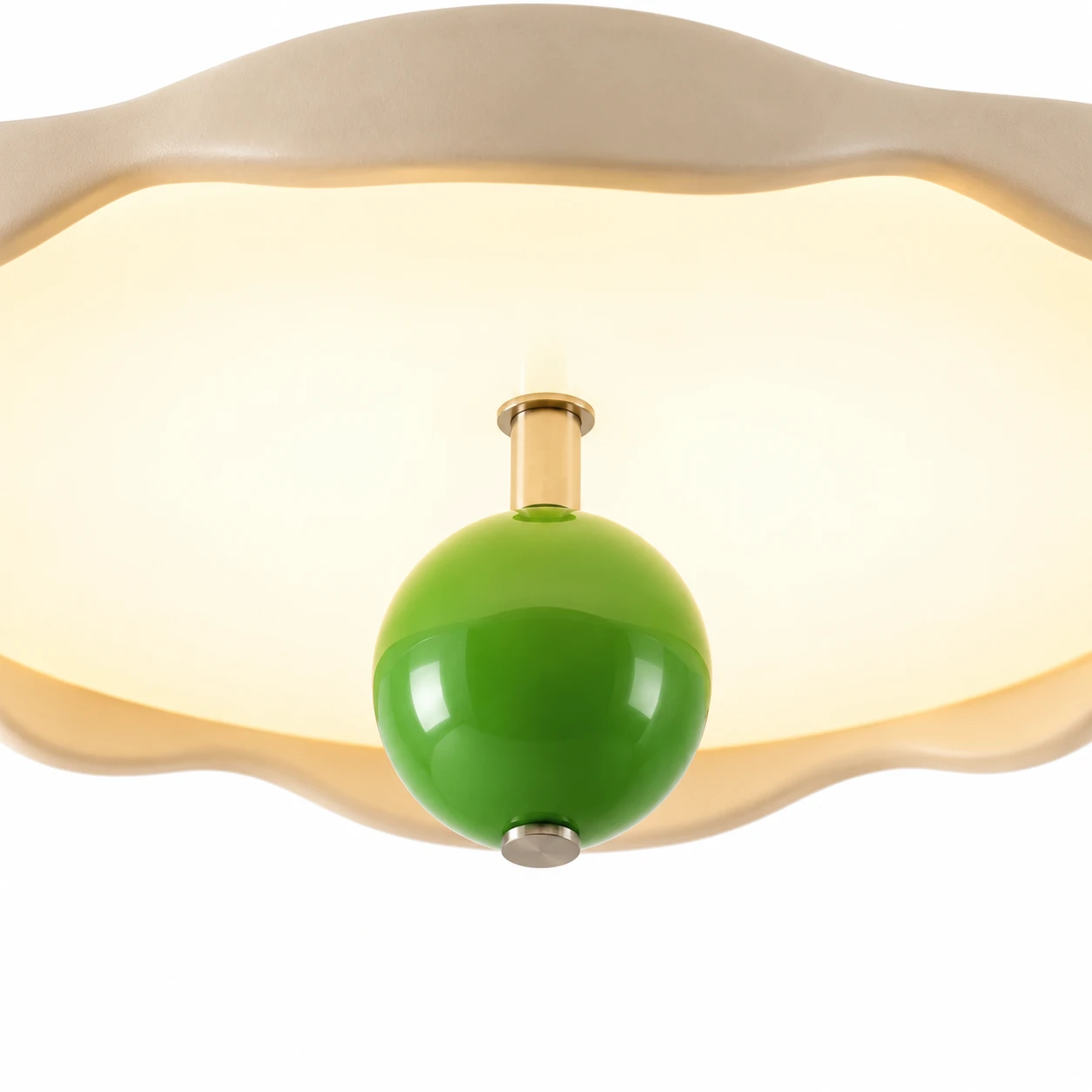 Close detail of the green metal drop orb under the lit wavy shade