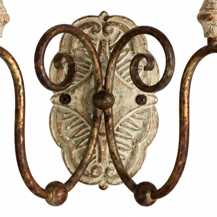 Close view of the carved wood backplate and scrolling iron arms