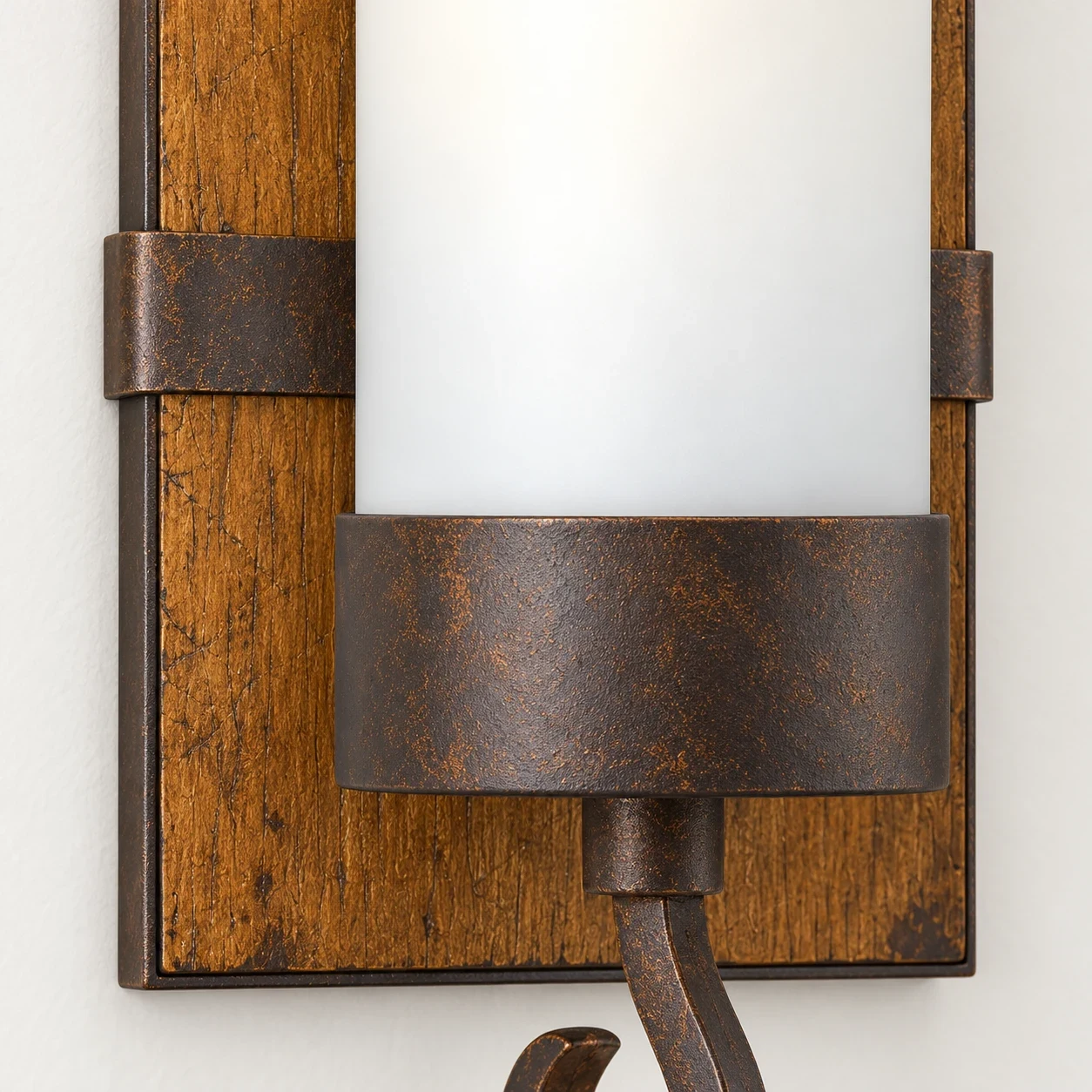 Close view of the stained wood backplate and dark bronze iron band