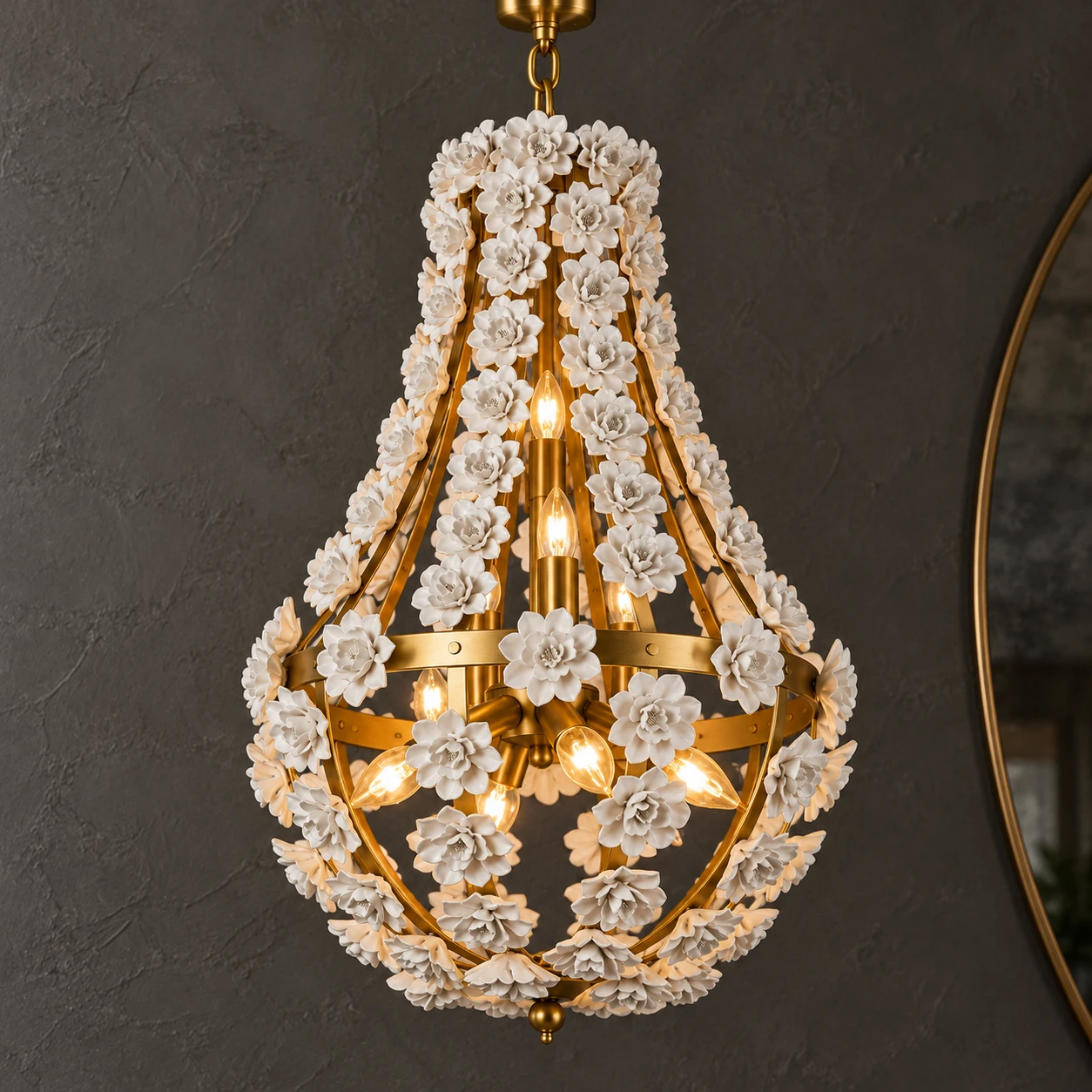 Close view of the gold floral teardrop chandelier on deep charcoal