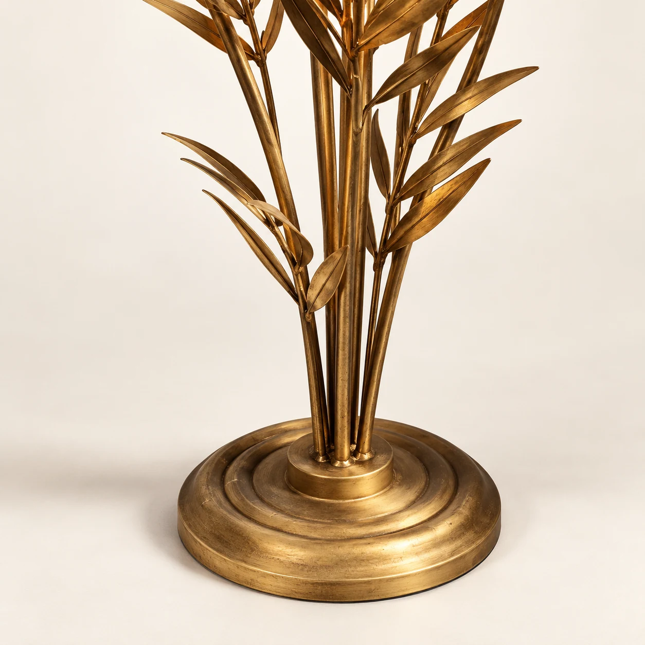 Close detail of the round iron base and stems on the Liora floor lamp