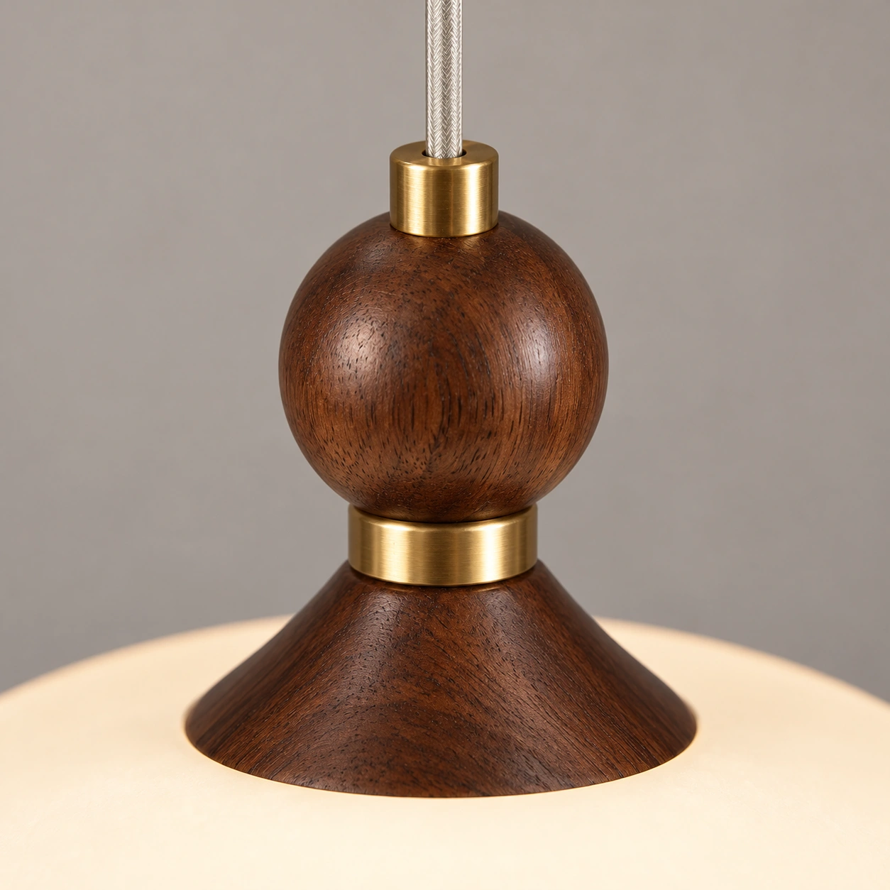 Close detail of the walnut sphere and brass connector