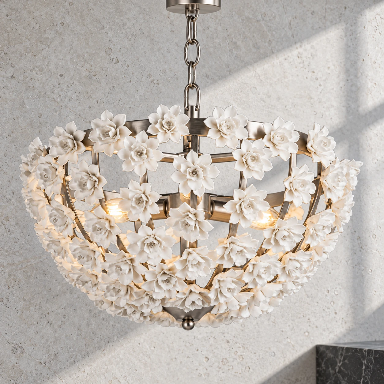 Close view of the silver floral bowl chandelier on cool limestone