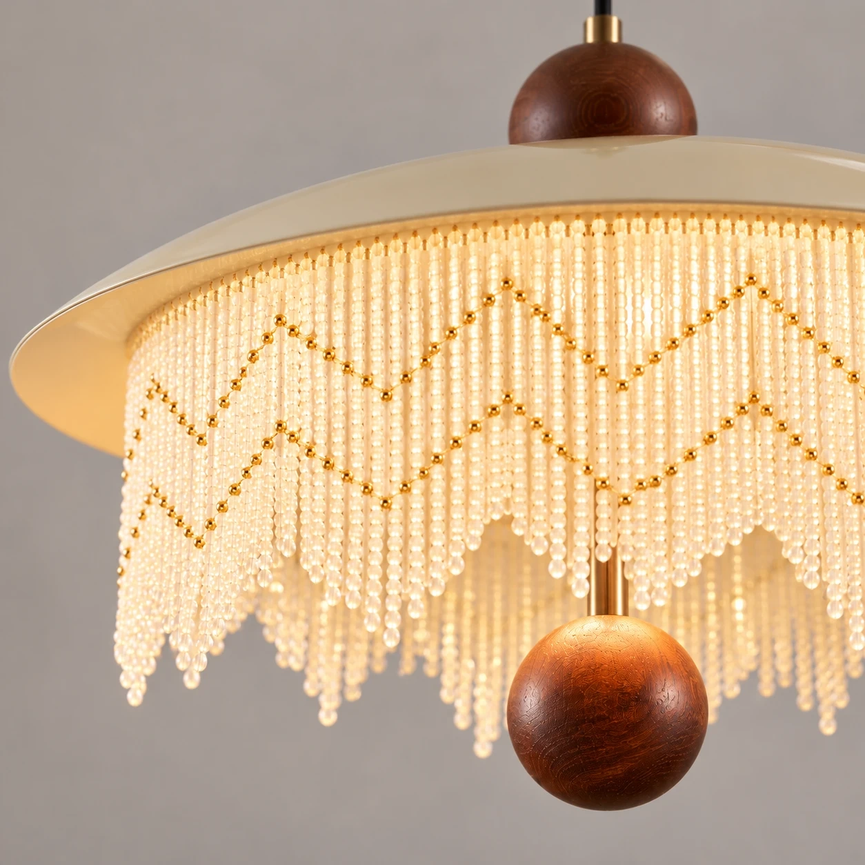 Close view of the lower wood sphere and beaded fringe edge