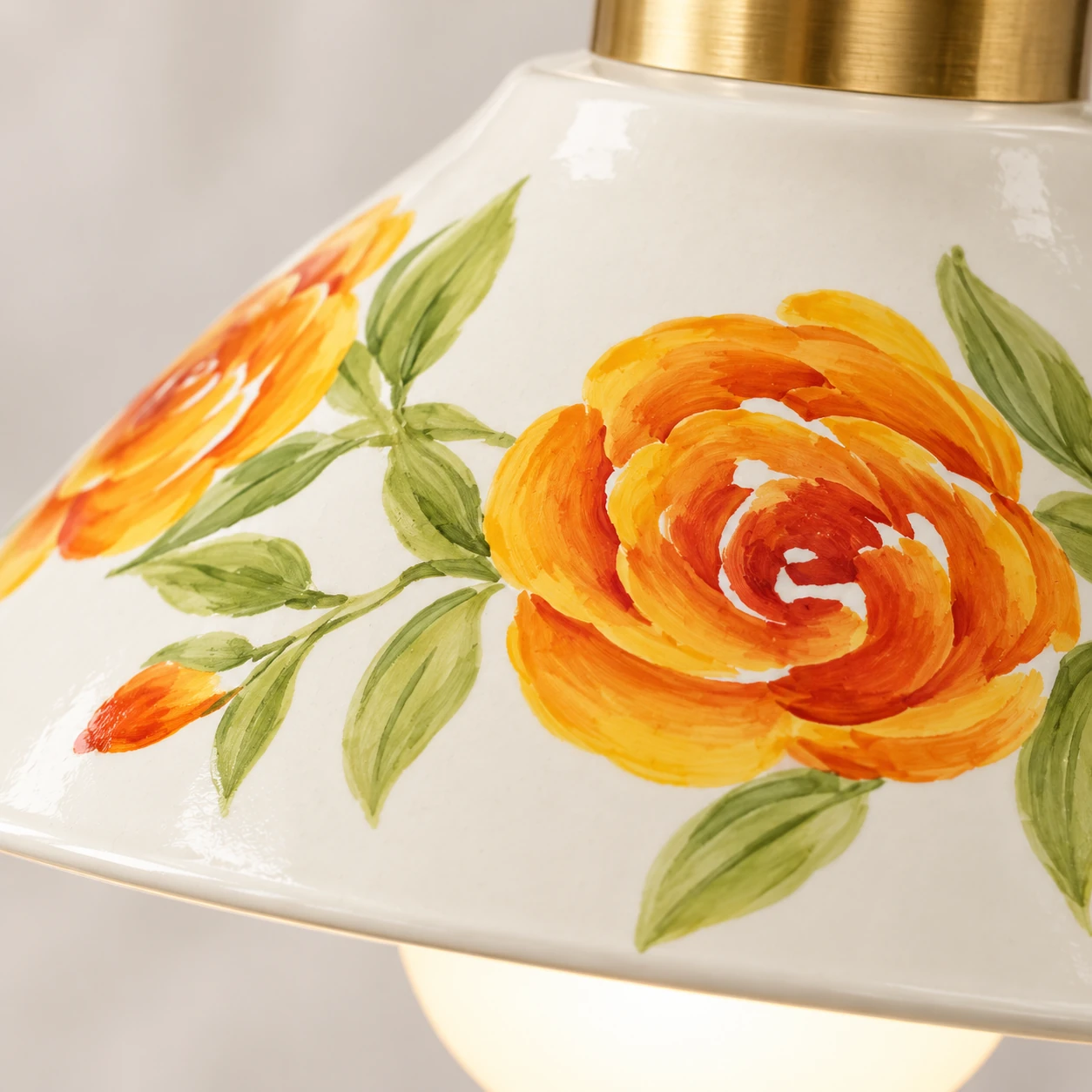 Close-up of hand-painted peony glaze on cream ceramic shade