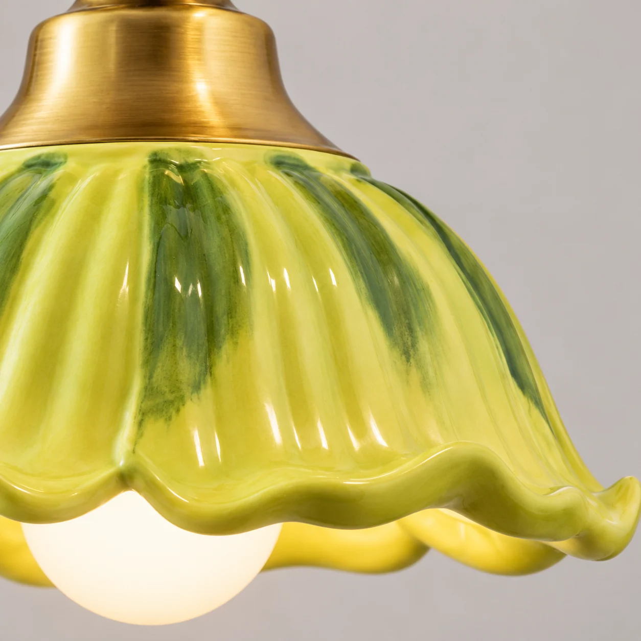 Close detail of yellow-green fluted ceramic glaze rim
