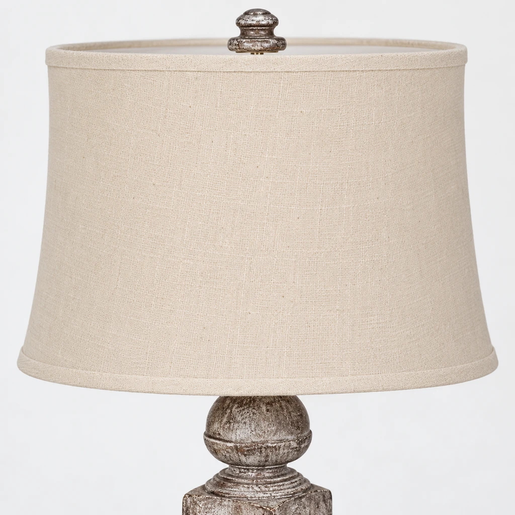 Close detail of the cream fabric shade and finial