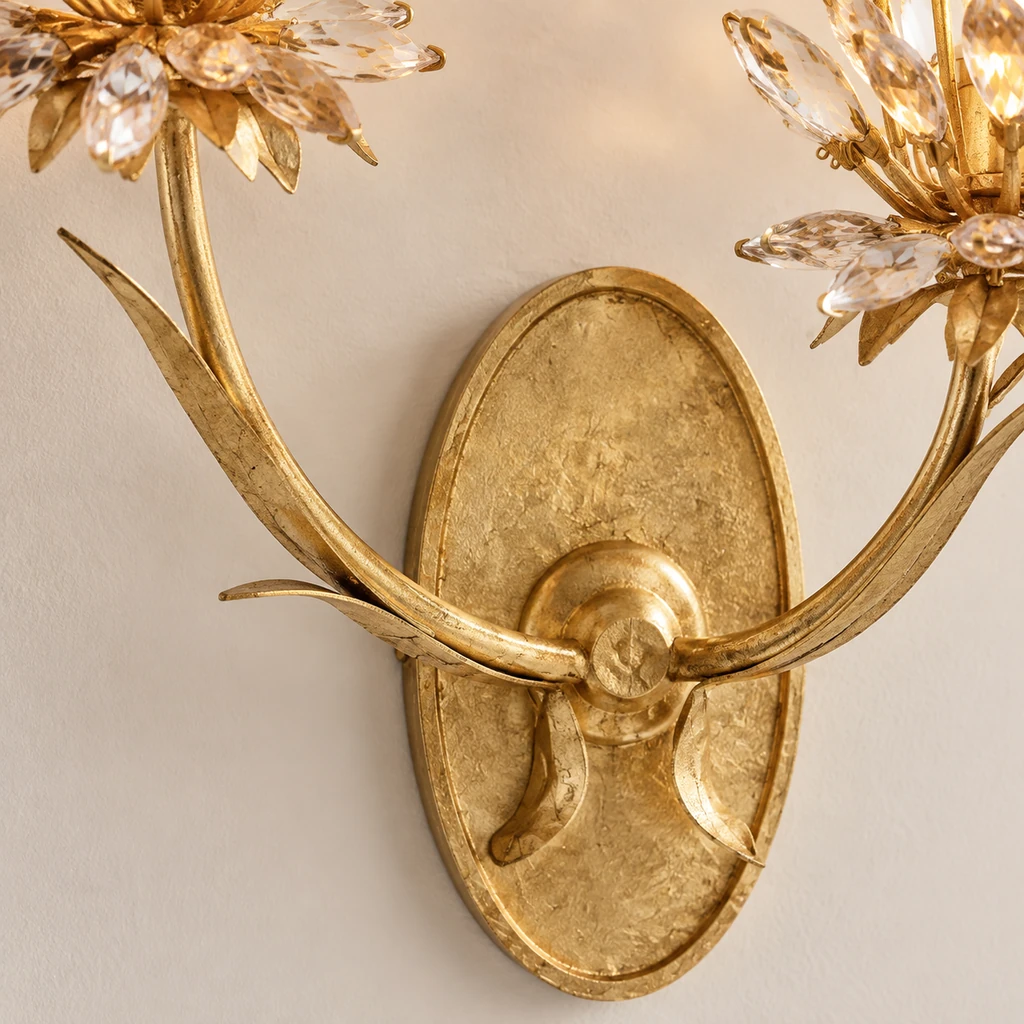 Close detail of Aria gold-leaf metal branch and oval backplate