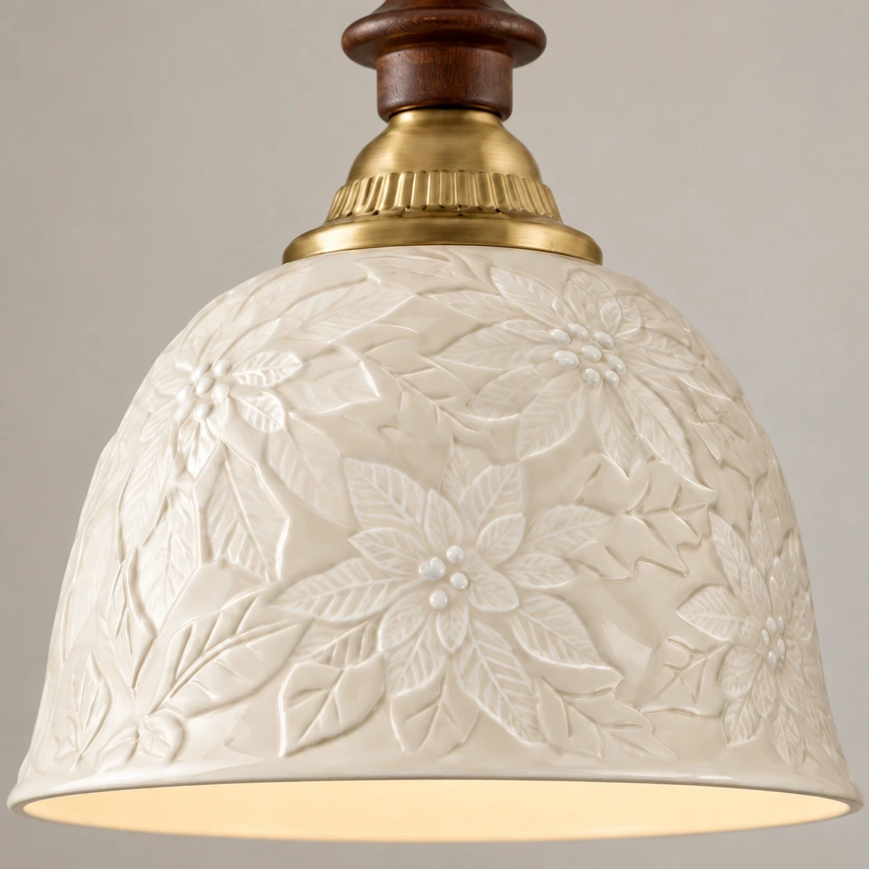 Close view of the ivory ceramic bell shade and raised floral relief
