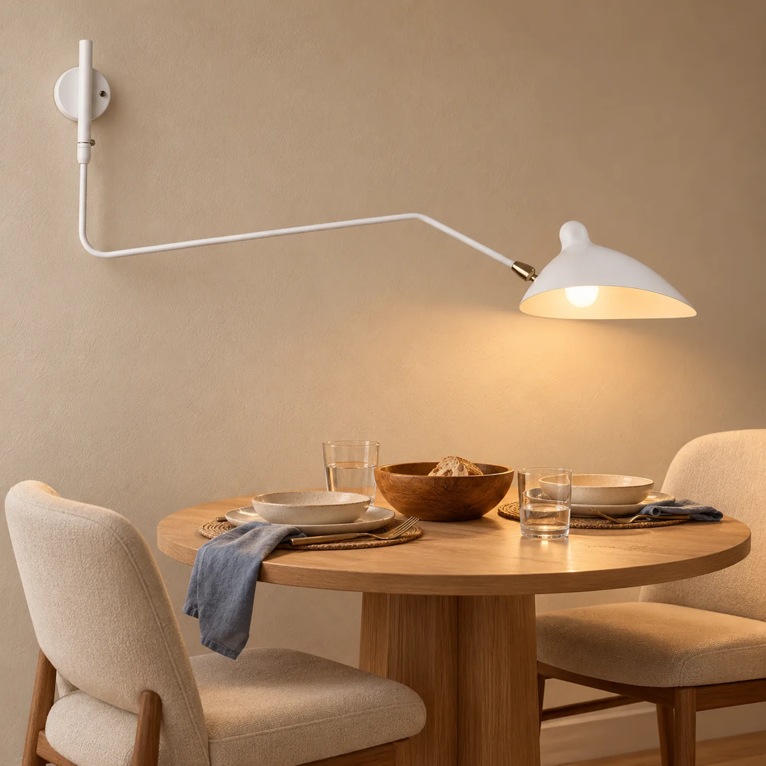 White one-arm wall lamp in a dining nook