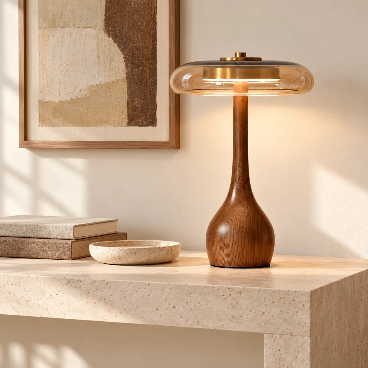 Tall walnut lamp on a limestone console beside books