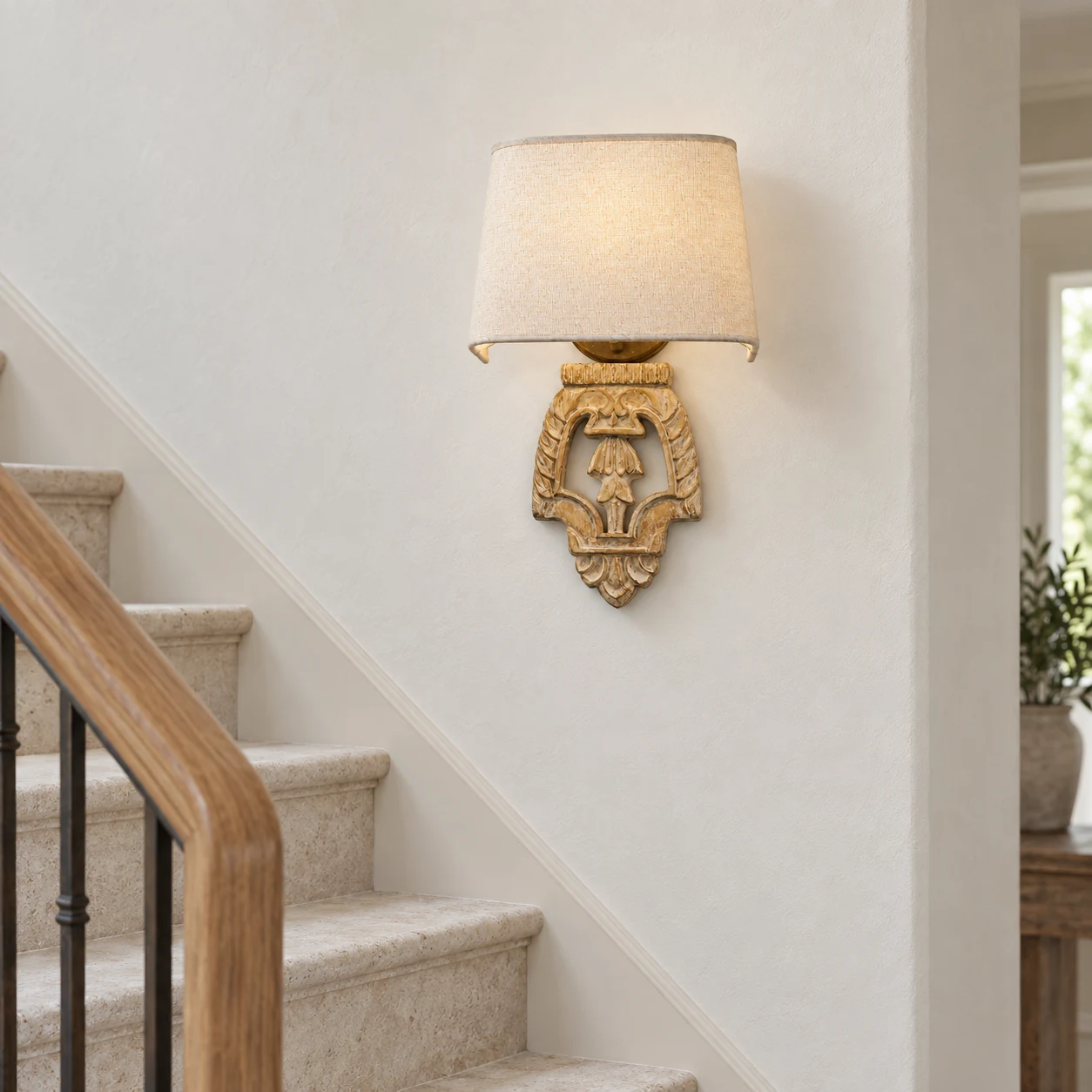 Amelie carved relief wall light at a stair landing
