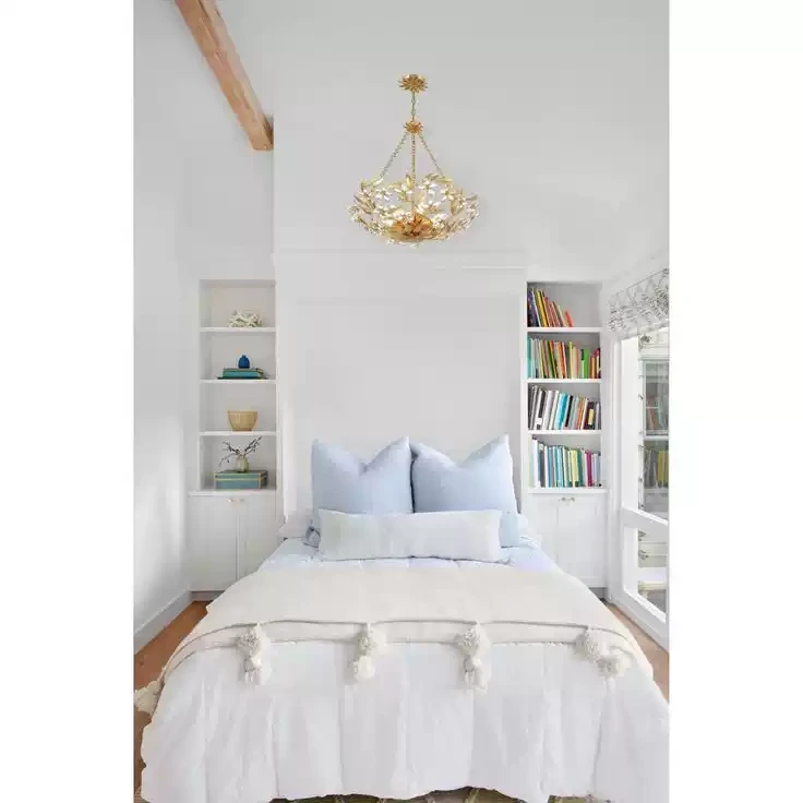 Crystal flower pendant light installed above a bed
