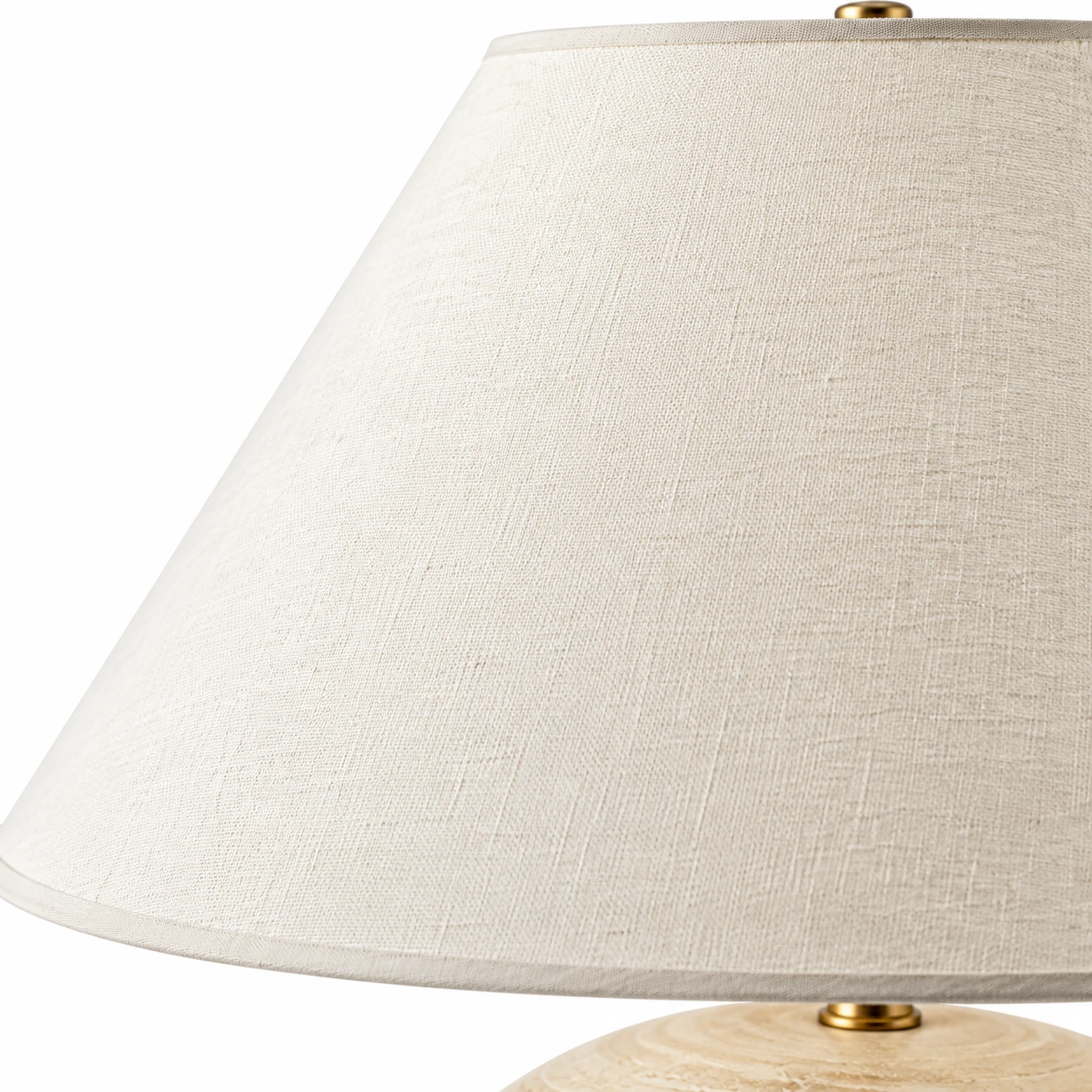 Close detail of the warm-ivory fabric shade and slim lower edge