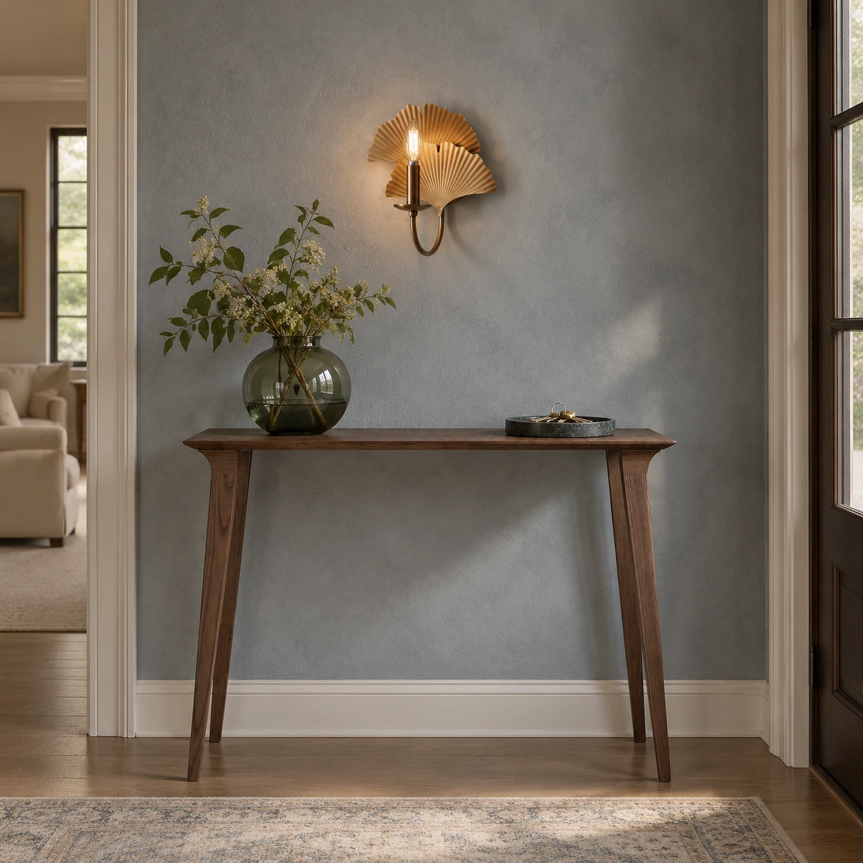 Exposed-bulb copper ginkgo sconce in an entryway