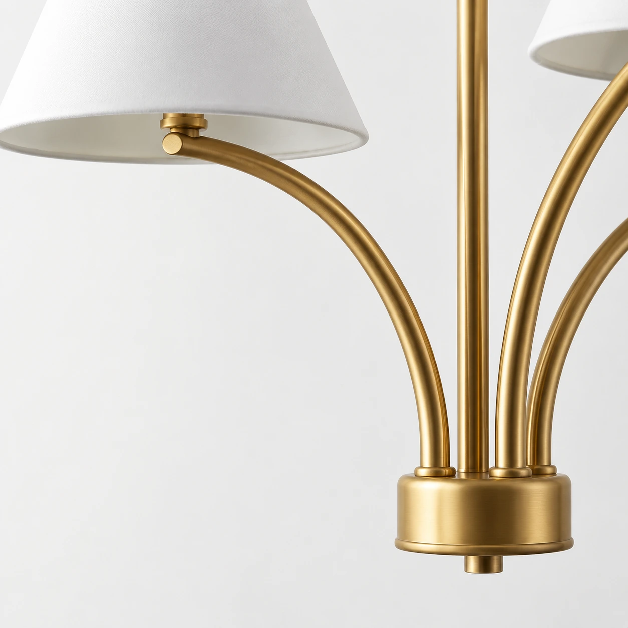 Close view of the warm brass arm and shade connection