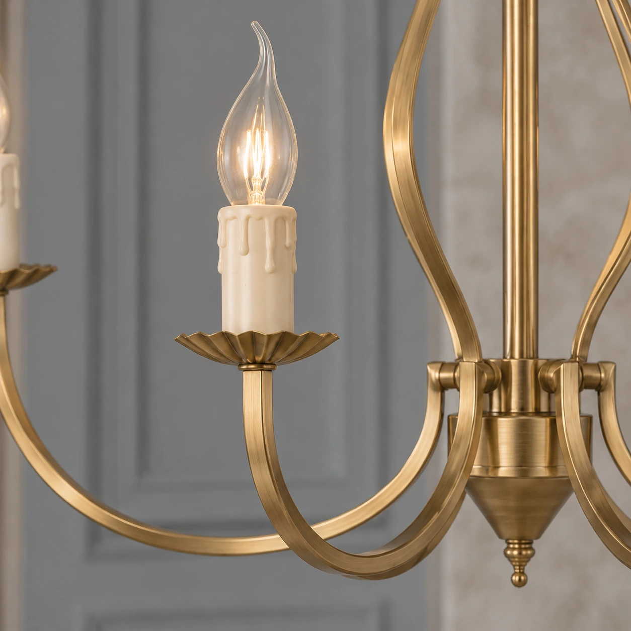 Close view of the Celeste chandelier candle arm junction and vintage-gold iron finish