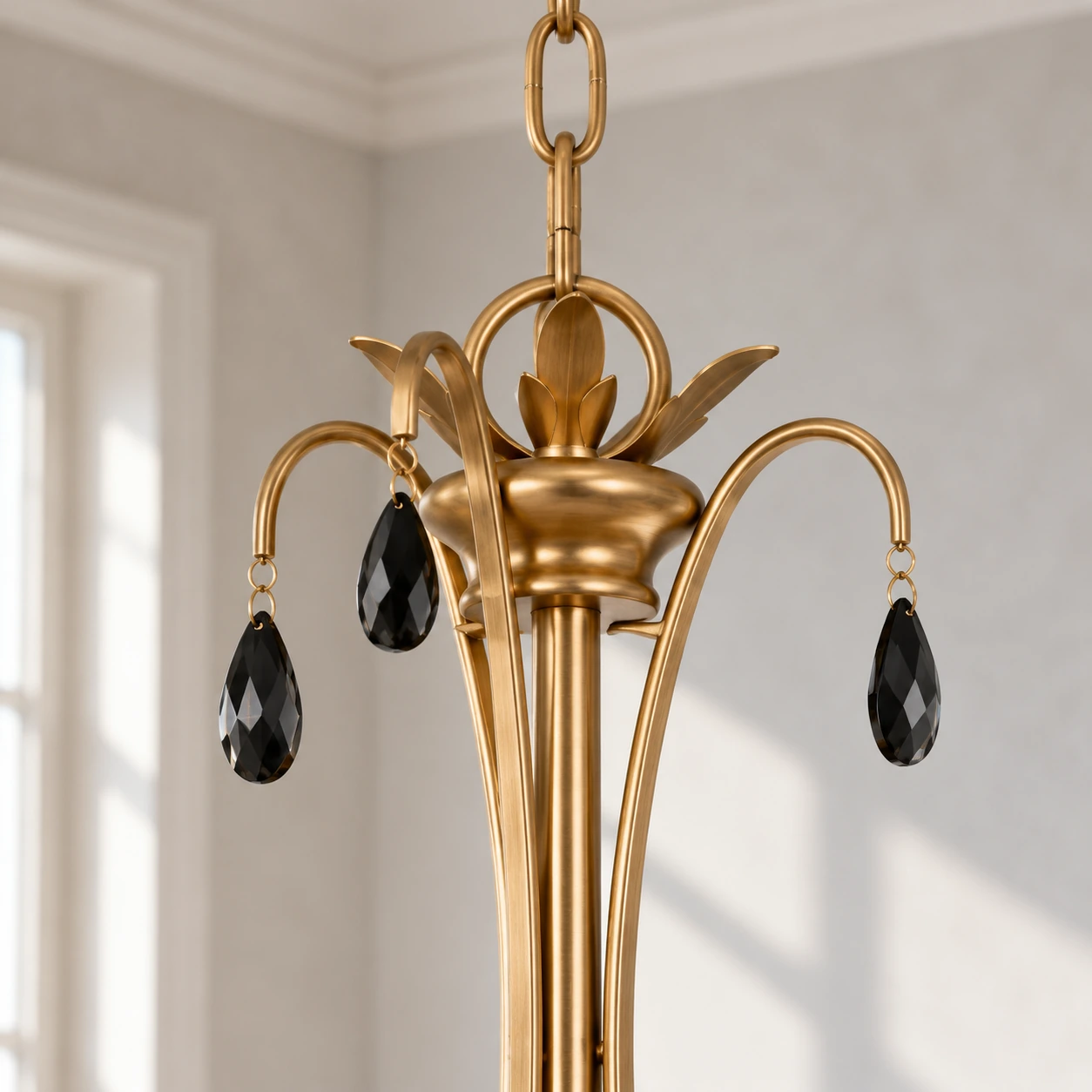 Close view of the Celeste chandelier crown, vintage-gold ironwork and black crystal drop