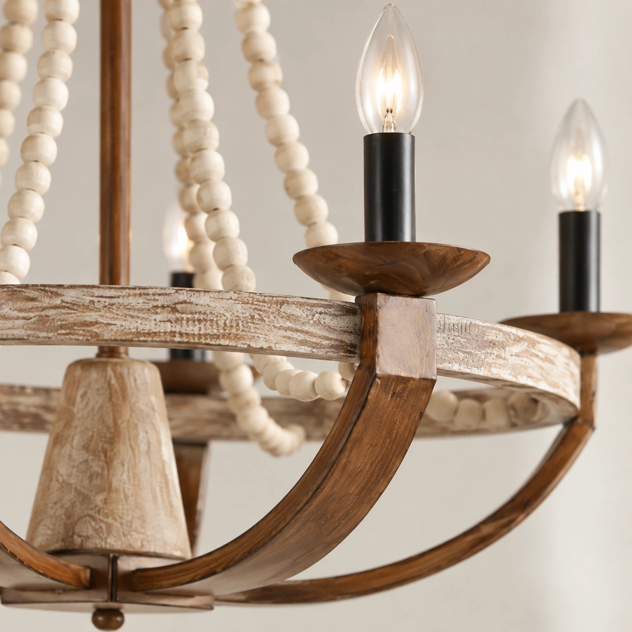 Close view of an antique wood chandelier arm and candle socket