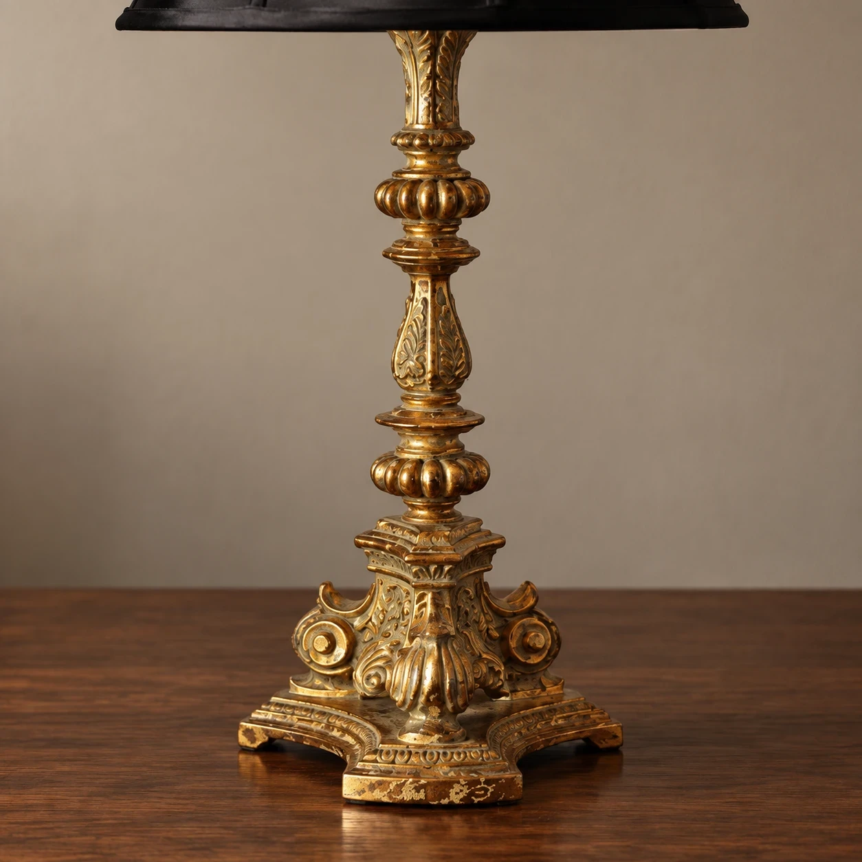 Close view of the carved wood lamp stem and ornate base