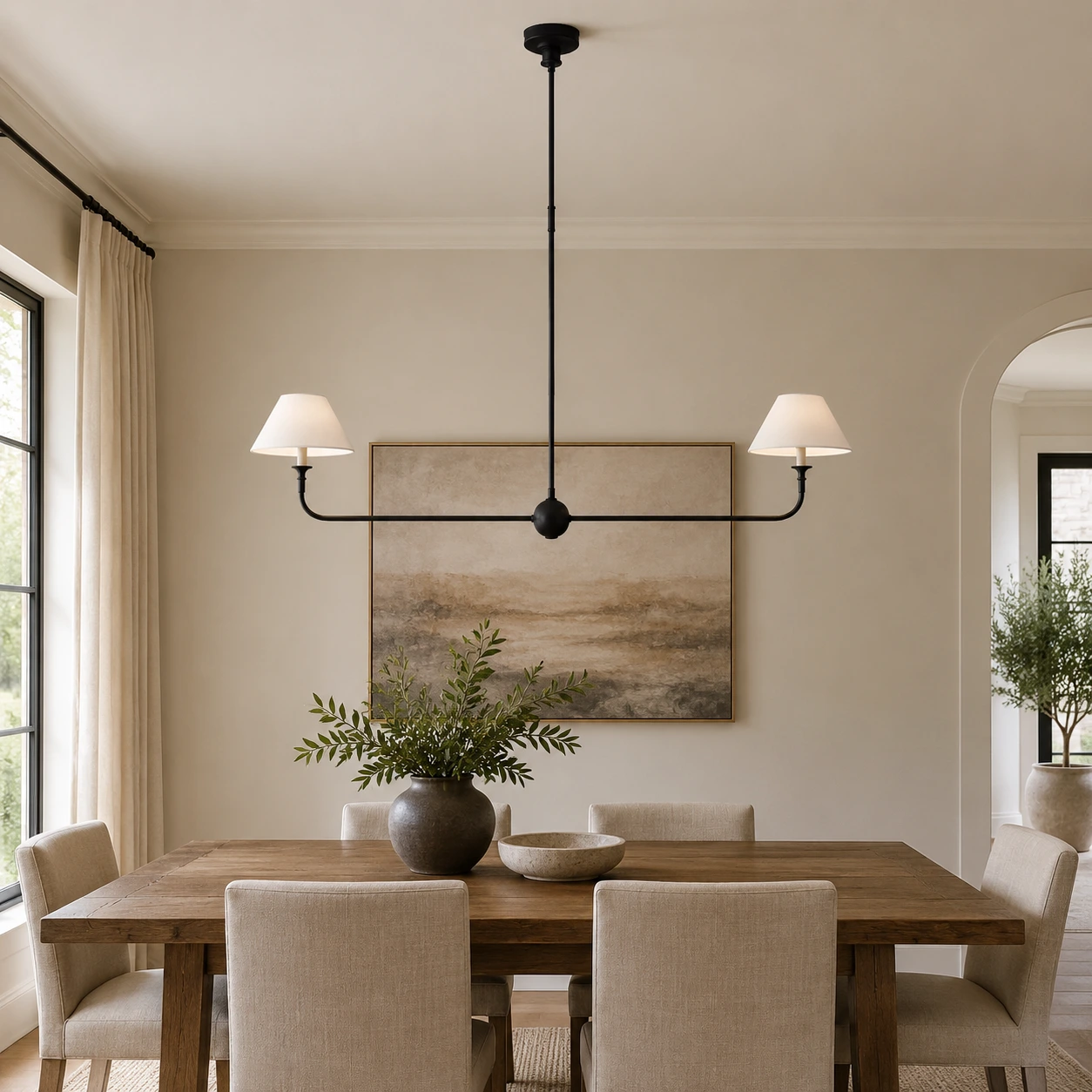 Black linear chandelier in a softly lit dining area
