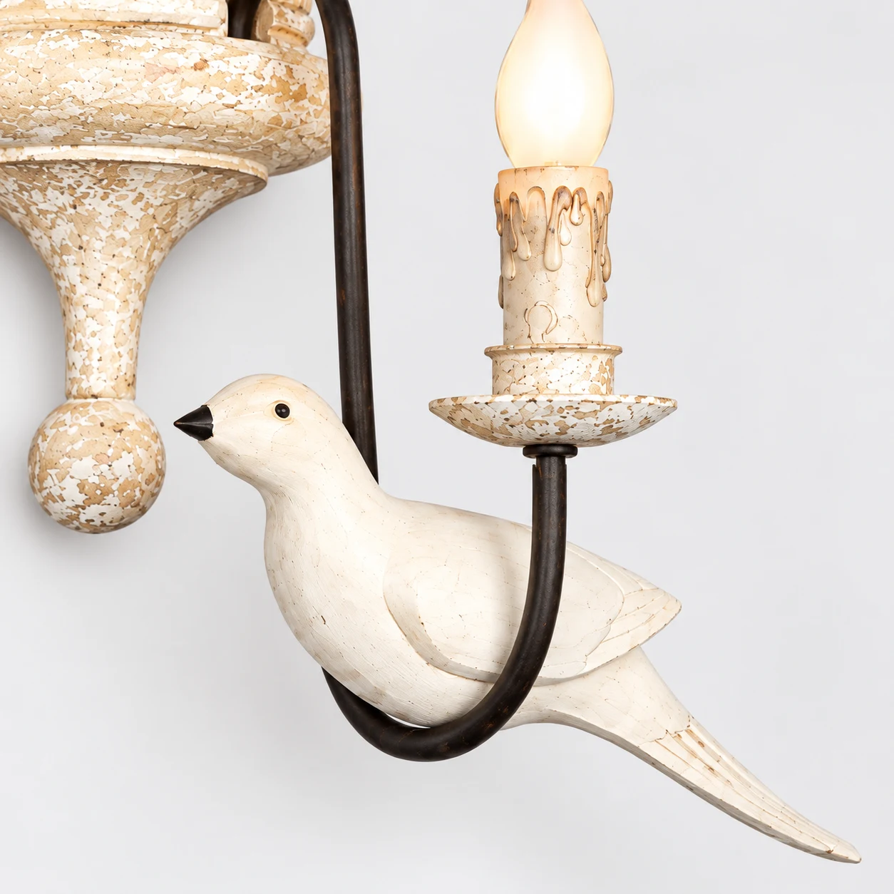 Mara carved bird ornament, dark iron arm and candle socket