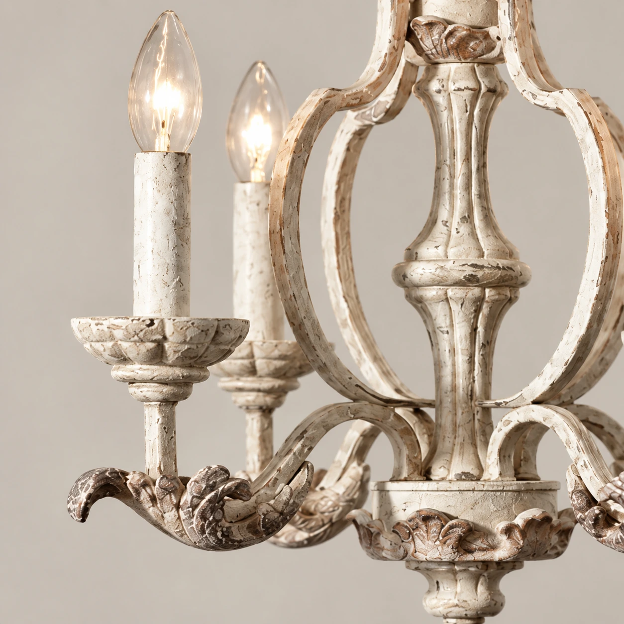 Close detail of carved wood arm and distressed finish