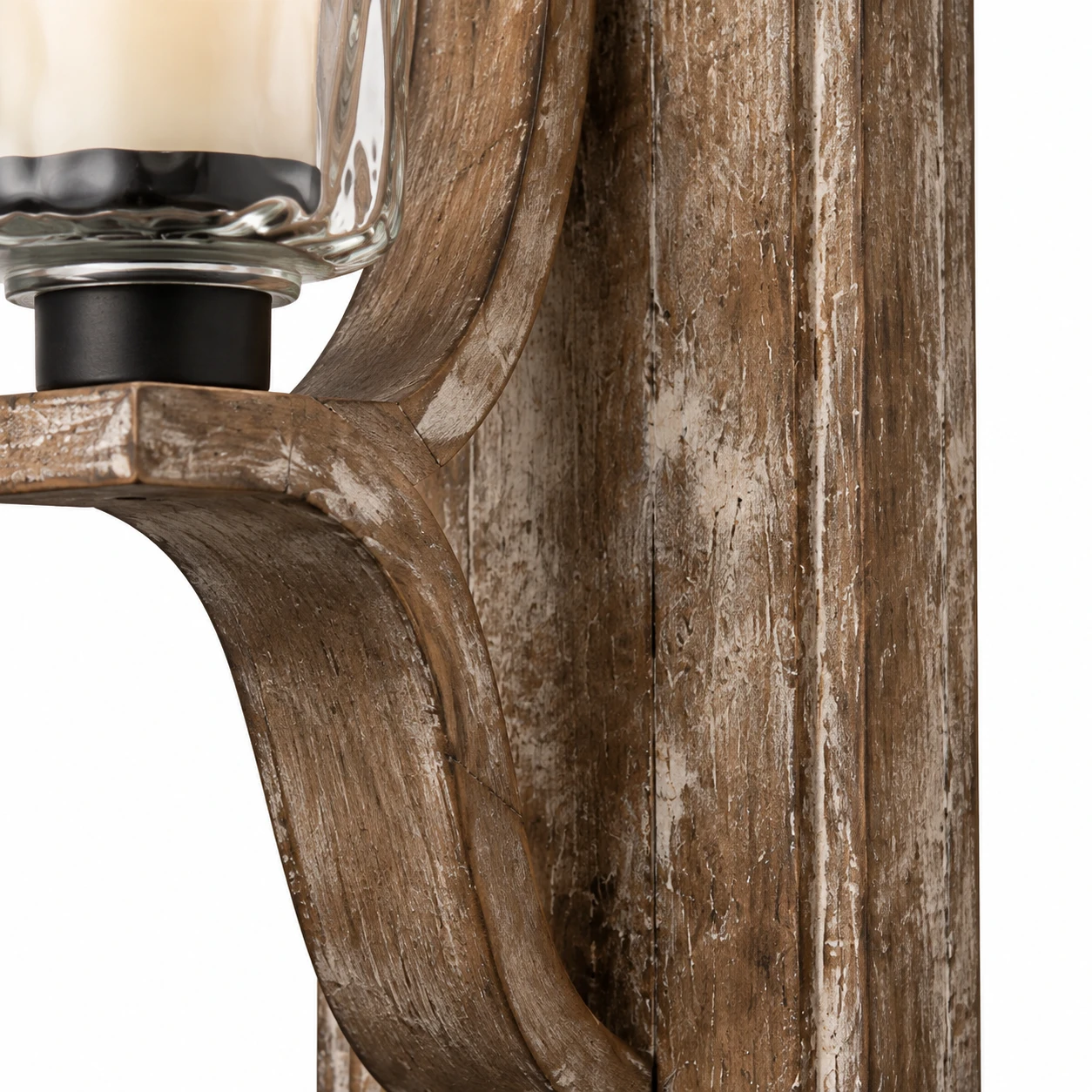 Close view of the carved aged wood backplate and curved arm