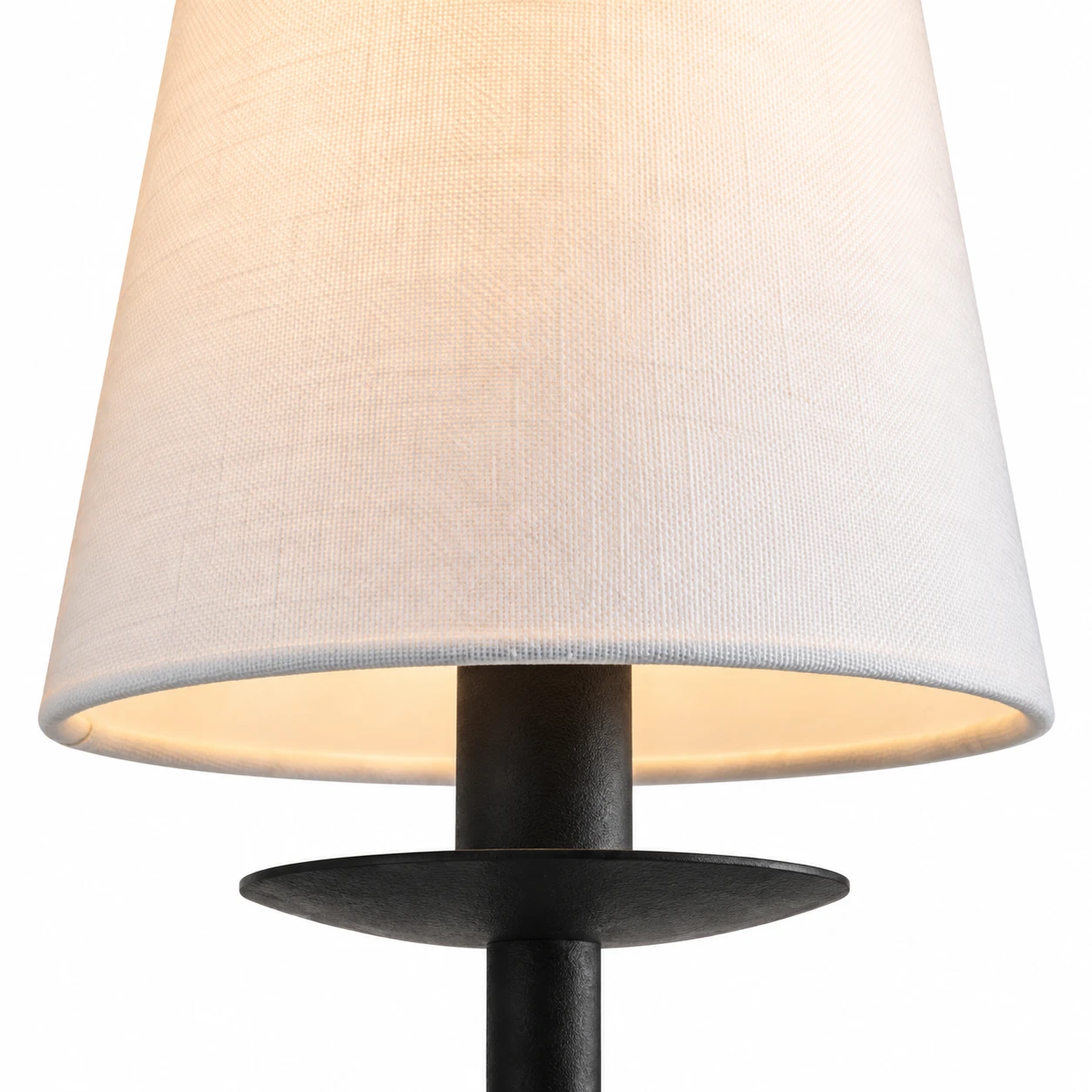 Close detail of the fabric shade and metal arm connection
