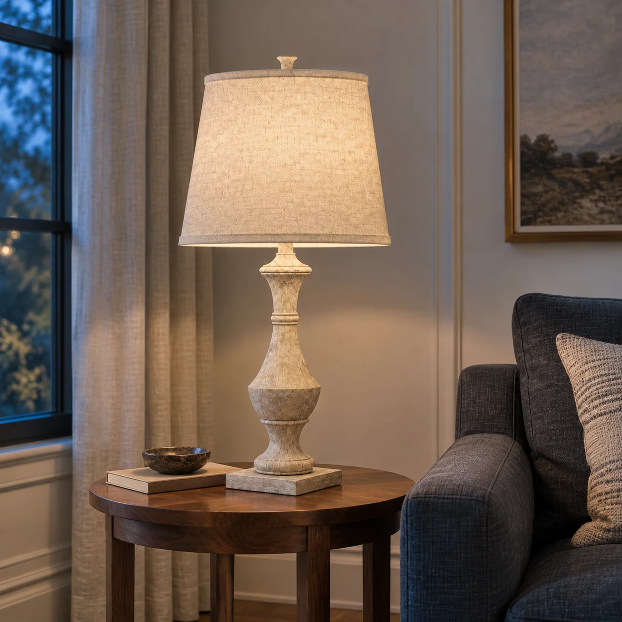 Carved wood table lamp glowing on a living room side table