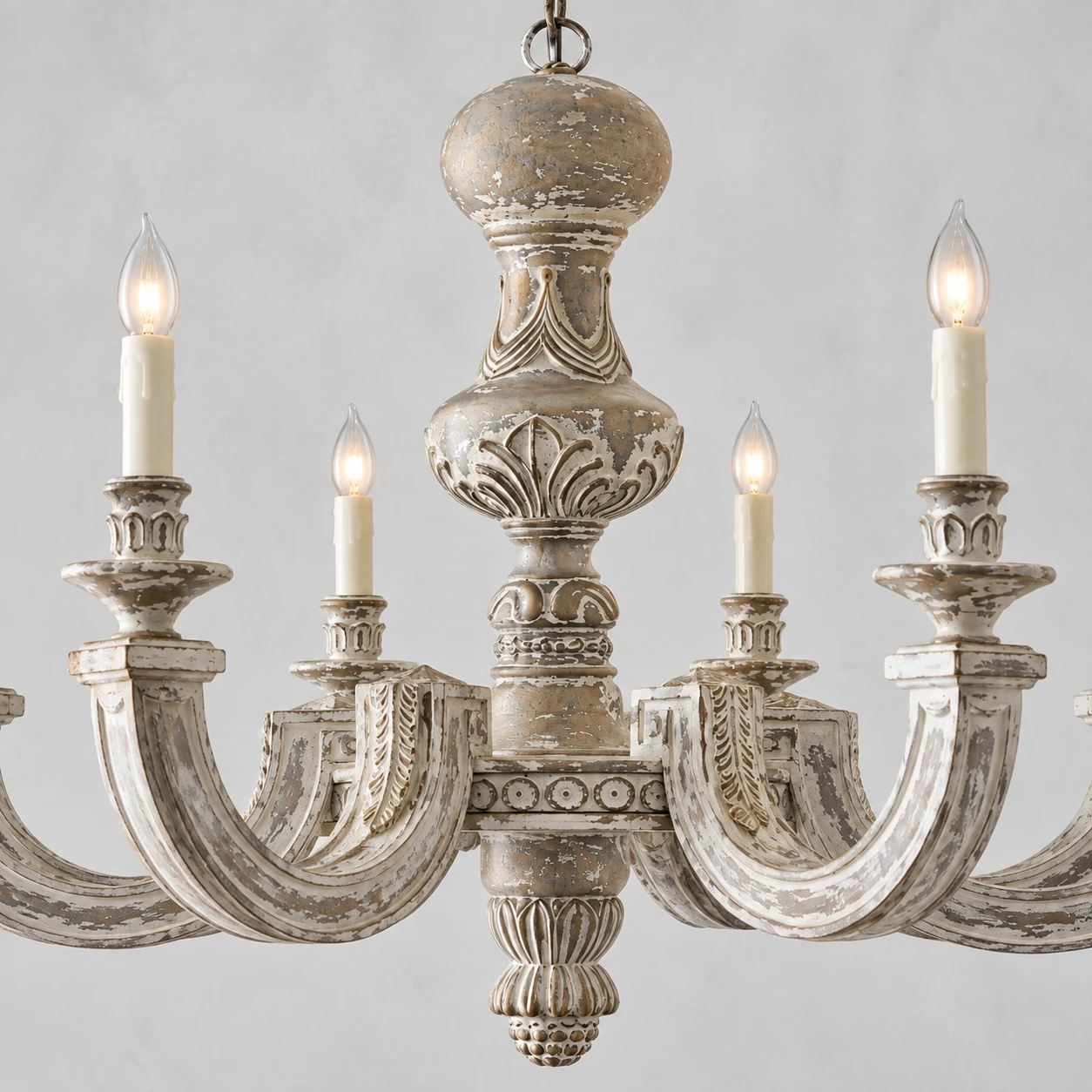 Close detail of carved wood, distressed finish and central urn form
