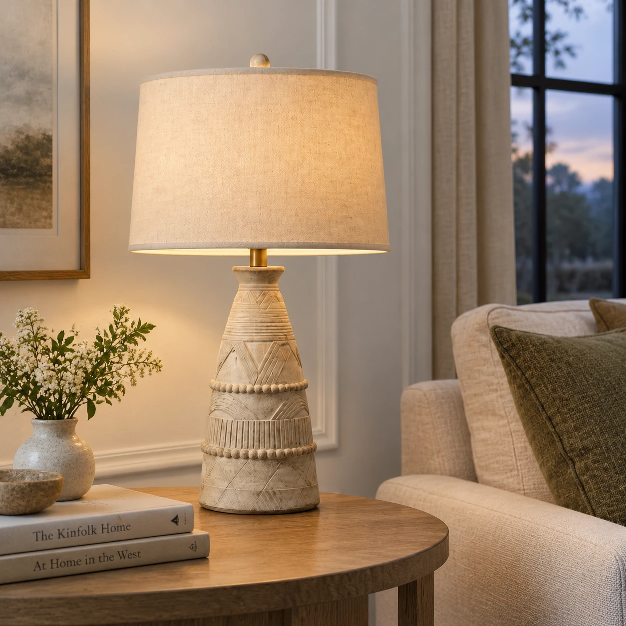 Carved wood table lamp beside a living-room sofa