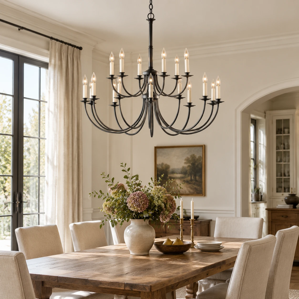 18-light iron chandelier over a dining table in a bright residential dining room