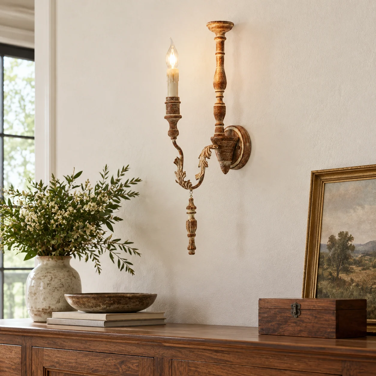 Brown carved wood wall sconce above dining sideboard